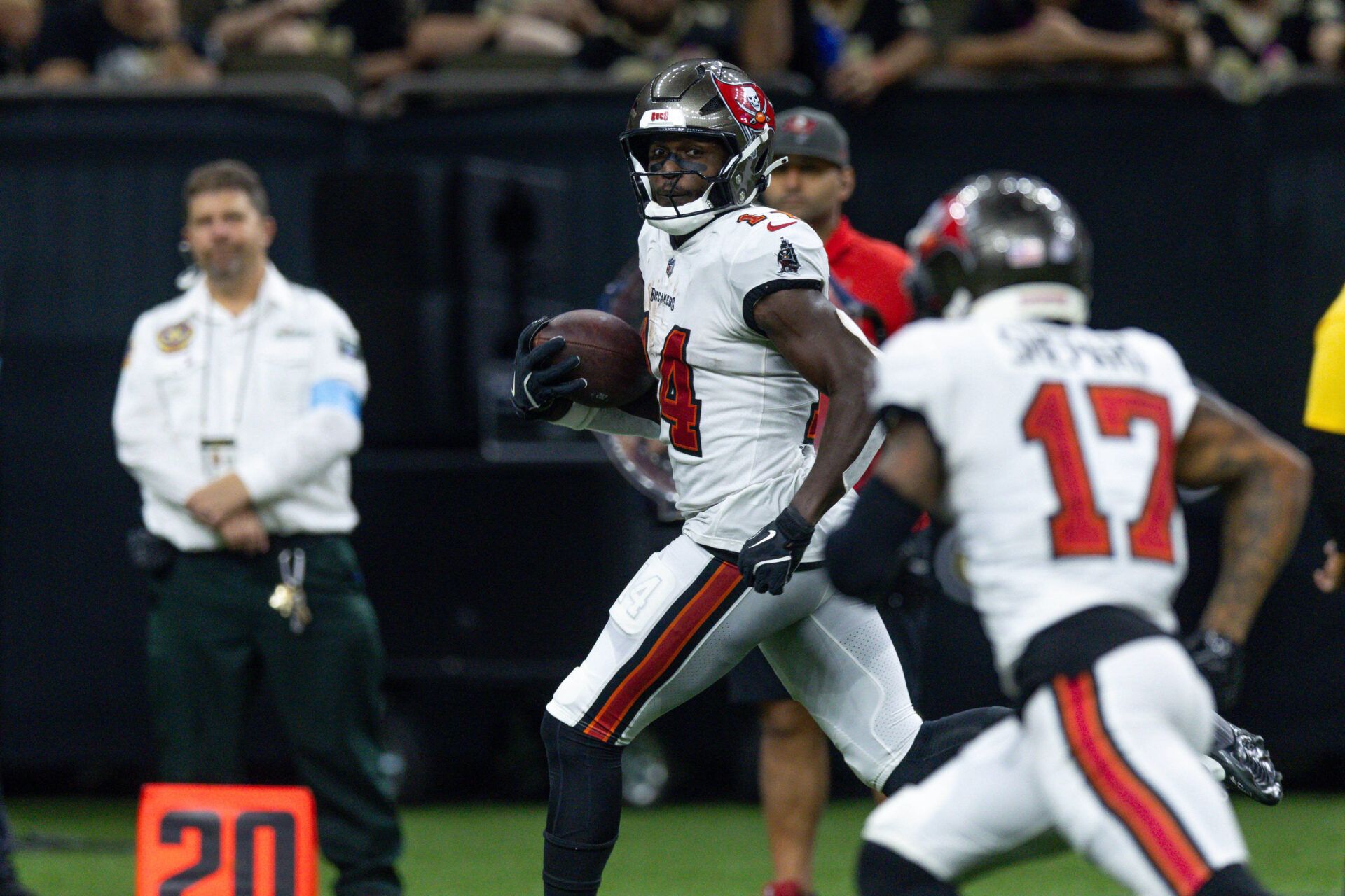 Oct 13, 2024; New Orleans, Louisiana, USA; Tampa Bay Buccaneers wide receiver Chris Godwin (14) looks back at wide receiver Sterling Shepard (17) as he runs in for a touchdown against the New Orleans Saints during the second half at Caesars Superdome. Mandatory Credit: Stephen Lew-Imagn Images