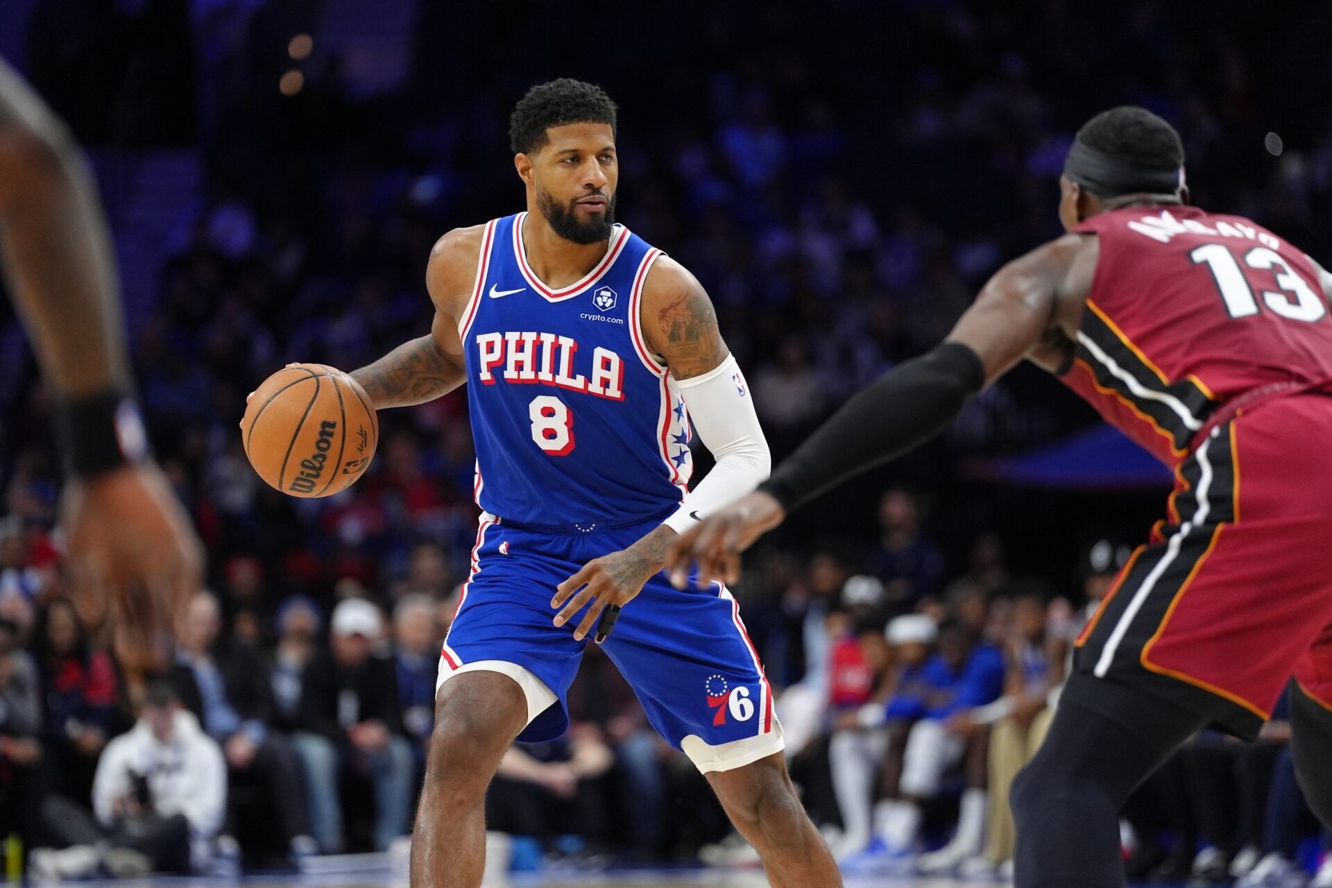 Philadelphia 76ers forward Paul George (8) controls the ball against the Miami Heat in the fourth quarter at Wells Fargo Center