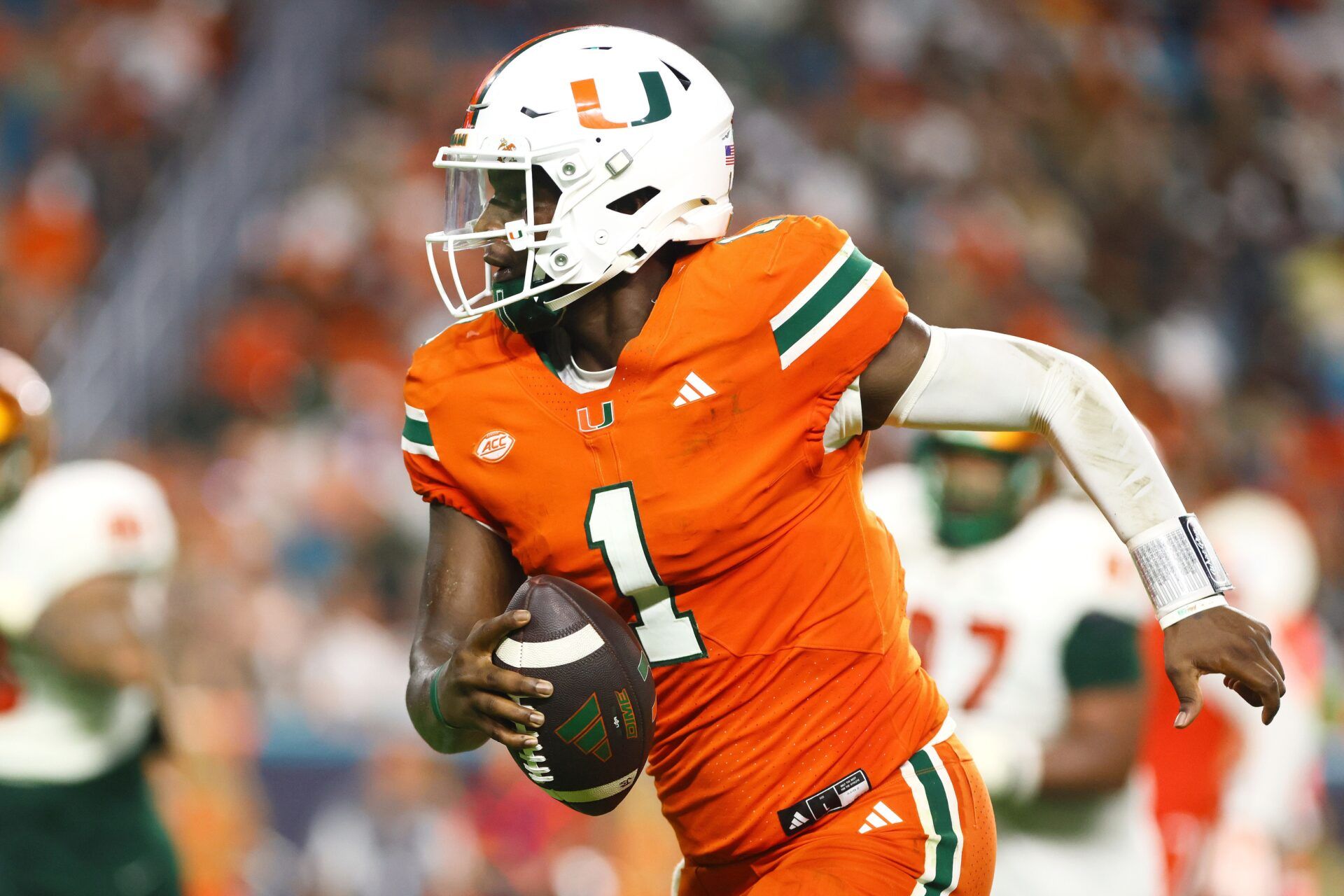 Miami Hurricanes quarterback Cam Ward (1) runs with the football for a touchdown against the Florida A&M Rattlers during the third quarter at Hard Rock Stadium.