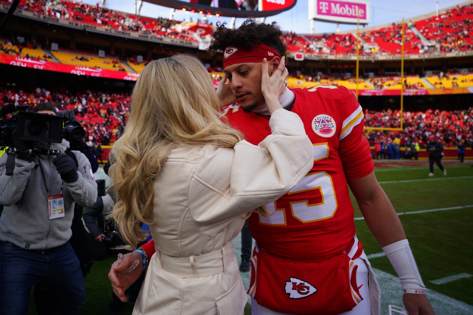 Kansas City Chiefs quarterback Patrick Mahomes (15) kisses his wife Brittany Mahomes before a 2025 AFC divisional round game against the Houston Texans at GEHA Field at Arrowhead Stadium.