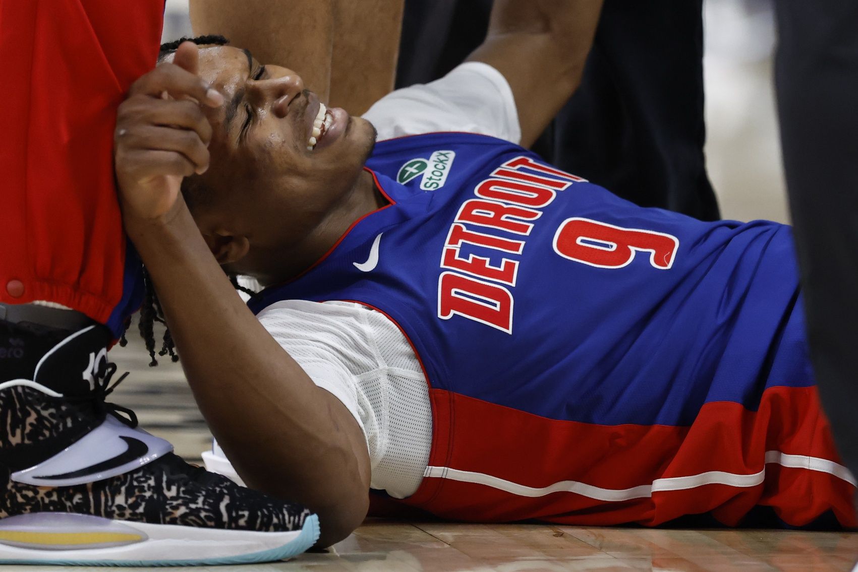 Detroit Pistons forward Ausar Thompson (9) winces in pain after he is injured in the second half against the Boston Celtics at Little Caesars Arena.