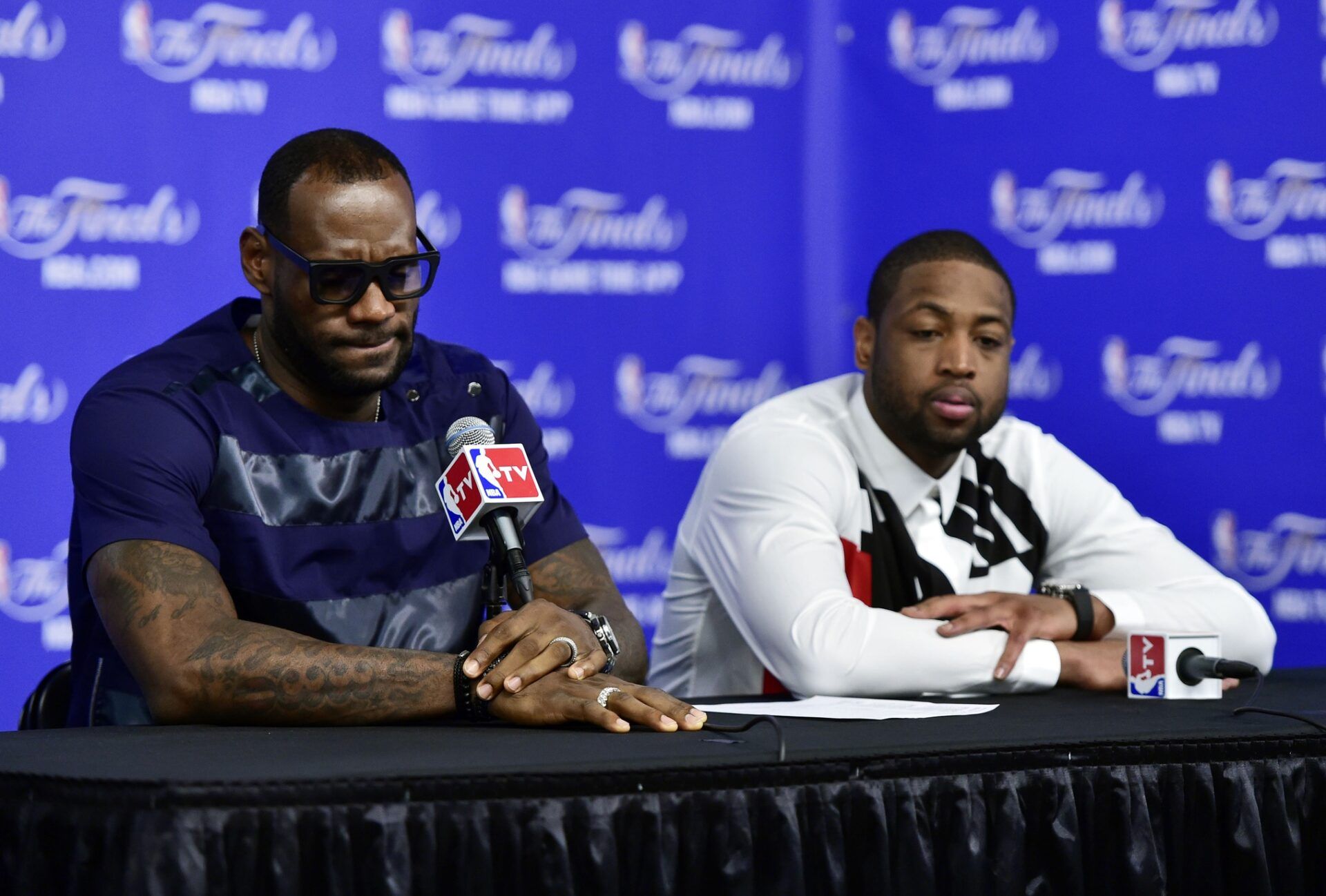 Miami Heat forward LeBron James (6) and guard Dwyane Wade (3) speak during a press conference after game five of the 2014 NBA Finals at AT&T Center.