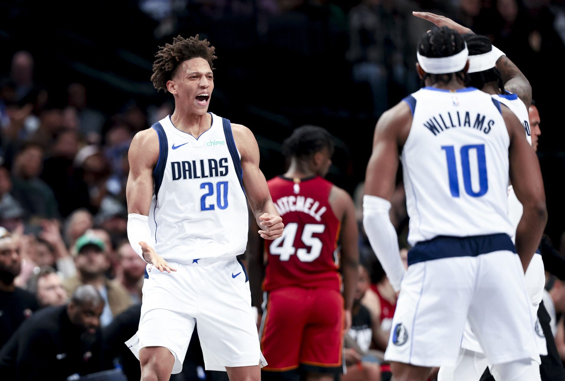 Dallas Mavericks forward Kessler Edwards (20) celebrates with Dallas Mavericks guard Brandon Williams (10) during the second half against the Miami Heat at American Airlines Center.