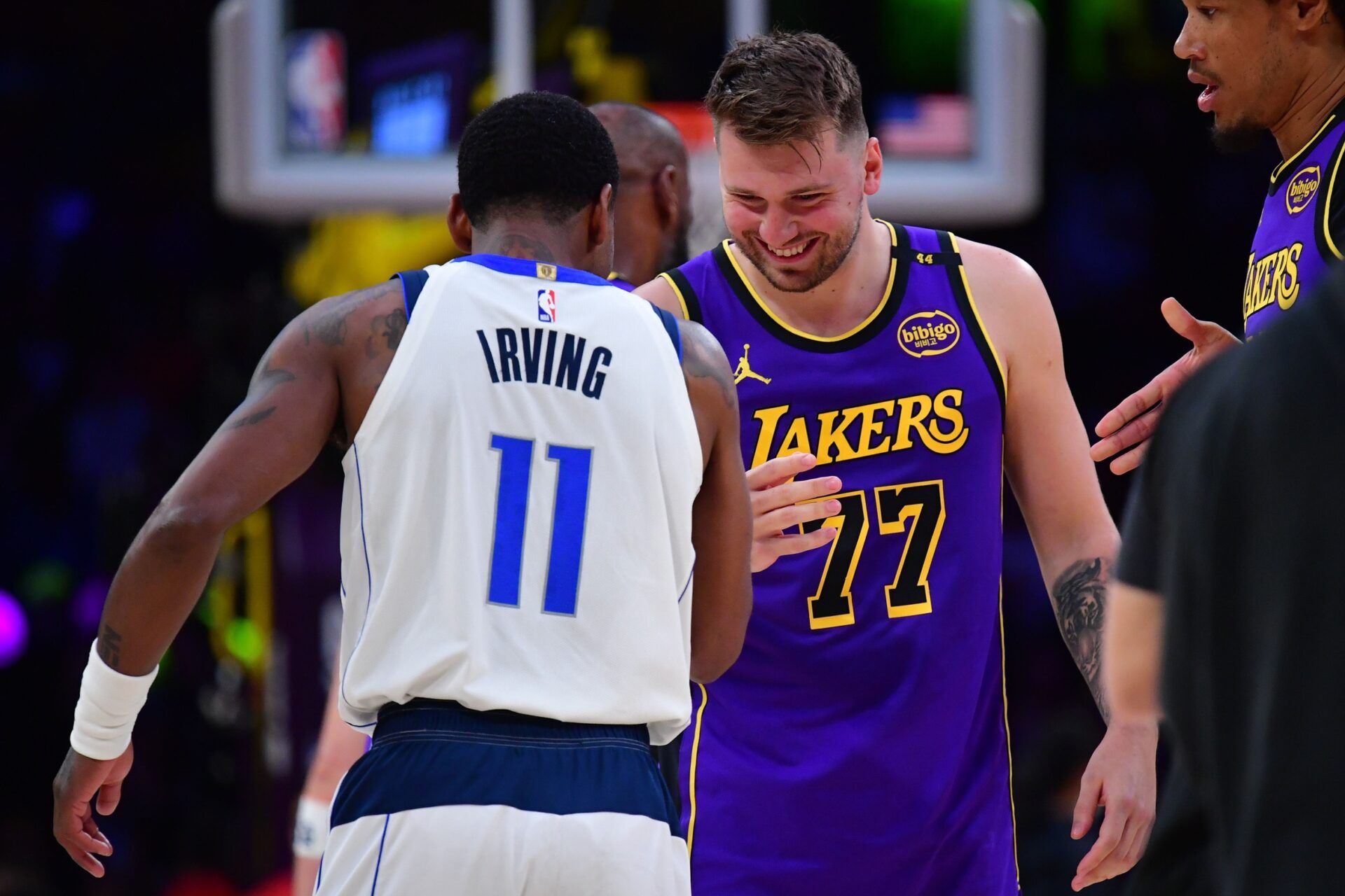 Los Angeles Lakers guard Luka Doncic (77) reacts with Dallas Mavericks guard Kyrie Irving (11) during the first quarter at Crypto.com Arena.