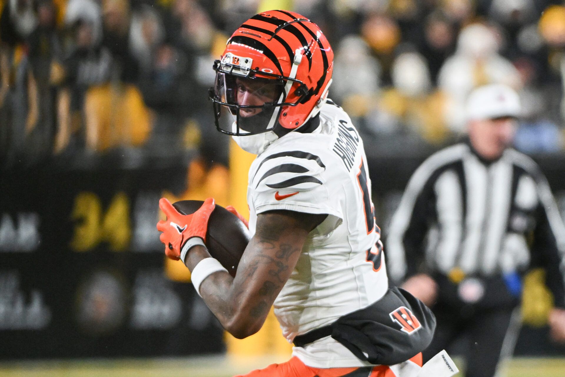 Jan 4, 2025; Pittsburgh, Pennsylvania, USA; Cincinnati Bengals wide receiver Tee Higgins (5) catches a pass against the Pittsburgh Steelers during the first quarter at Acrisure Stadium. Mandatory Credit: Barry Reeger-Imagn Images