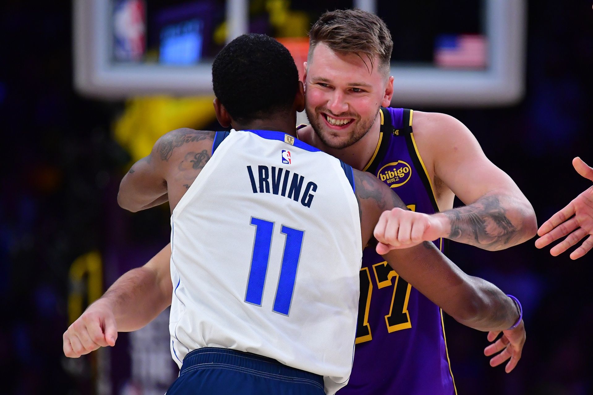 Los Angeles Lakers guard Luka Doncic (77) reacts with Dallas Mavericks guard Kyrie Irving (11) during the first quarter at Crypto.com Arena.