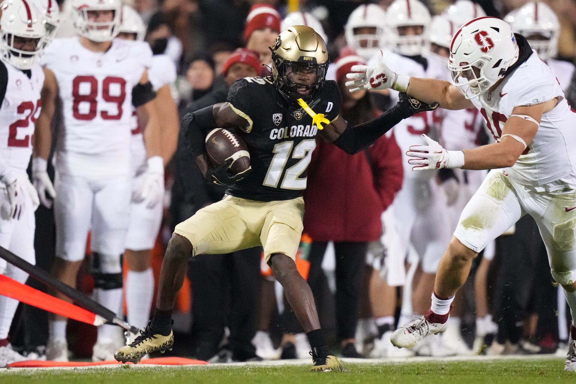 Oct 13, 2023; Boulder, Colorado, USA; Colorado Buffaloes cornerback Travis Hunter (12) carries the ball away from Stanford Cardinal linebacker Spencer Jorgensen (10) in the second quarter at Folsom Field. Mandatory Credit: Ron Chenoy-USA TODAY Sports