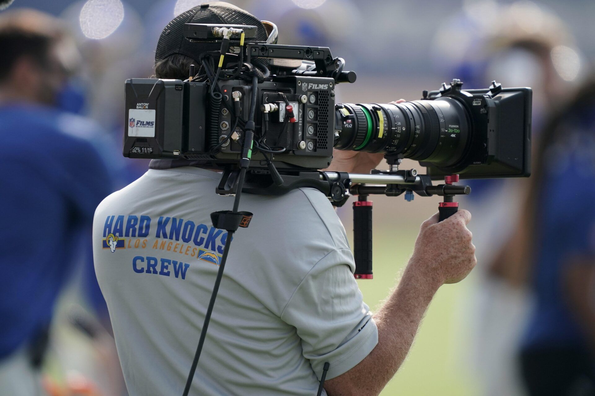 A HBO Hard Knocks cameraman films video footage during Los Angeles Rams training camp at Cal Lutheran University.