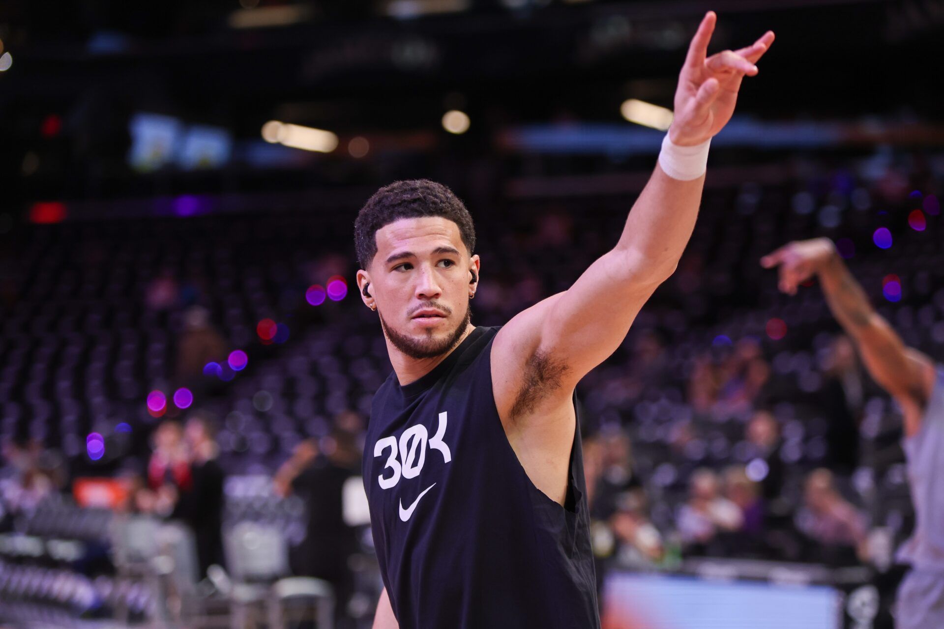 Phoenix Suns guard Devin Booker (1) waves to fans before a game against the New Orleans Pelicans at Footprint Center.