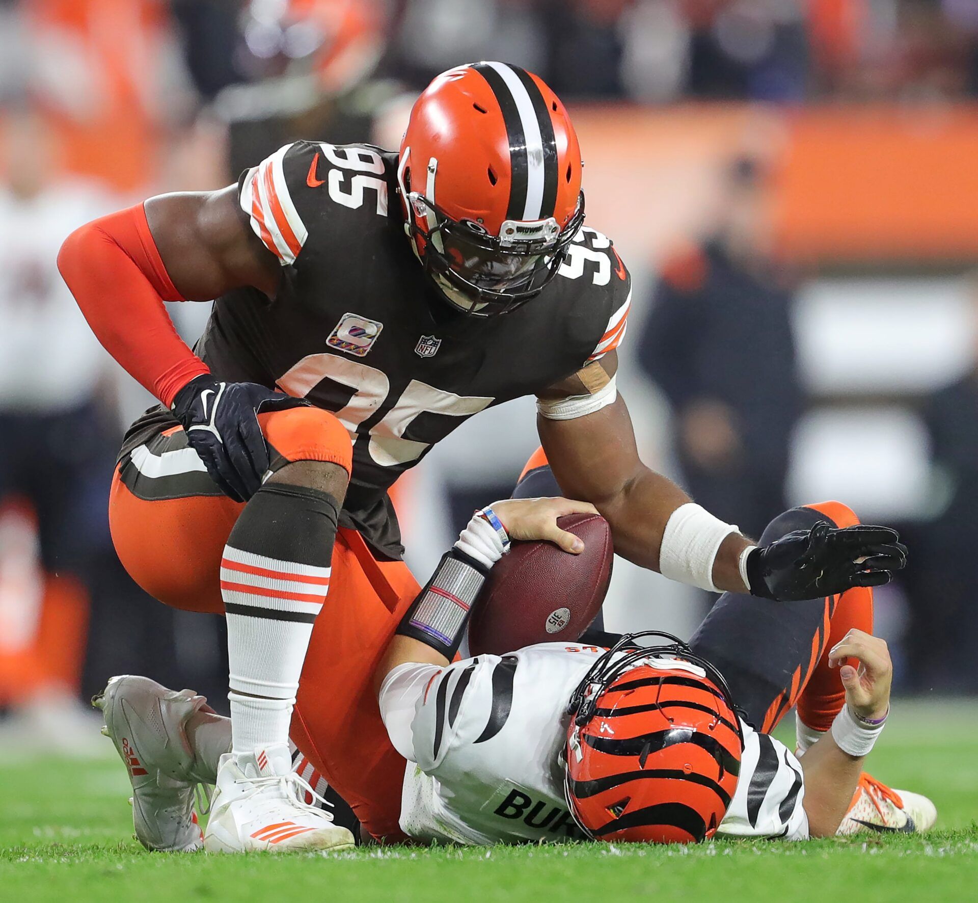 Cleveland Browns defensive end Myles Garrett (95) pats Cincinnati Bengals quarterback Joe Burrow (9) after sacking him during the second half of an NFL football game at FirstEnergy Stadium, Monday, Oct. 31, 2022, in Cleveland, Ohio. [Jeff Lange/Beacon Journal]