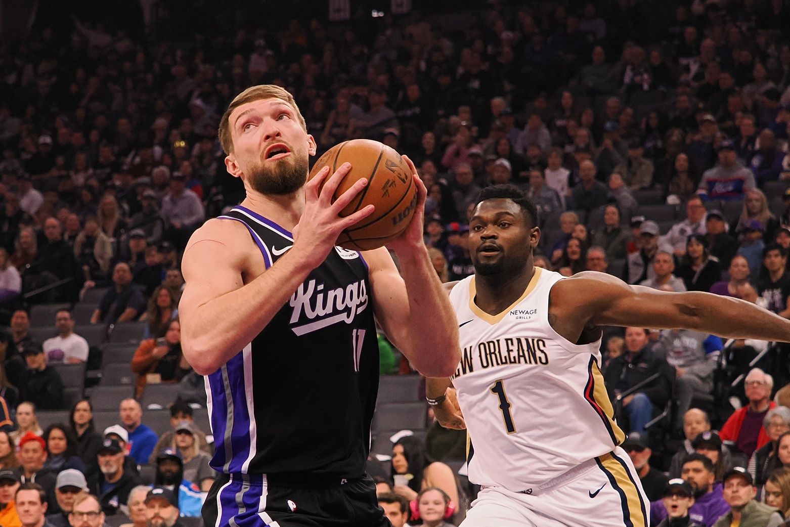 Sacramento Kings center Domantas Sabonis (11) controls the ball against New Orleans Pelicans forward Zion Williamson (1) during the first quarter at Golden 1 Center.