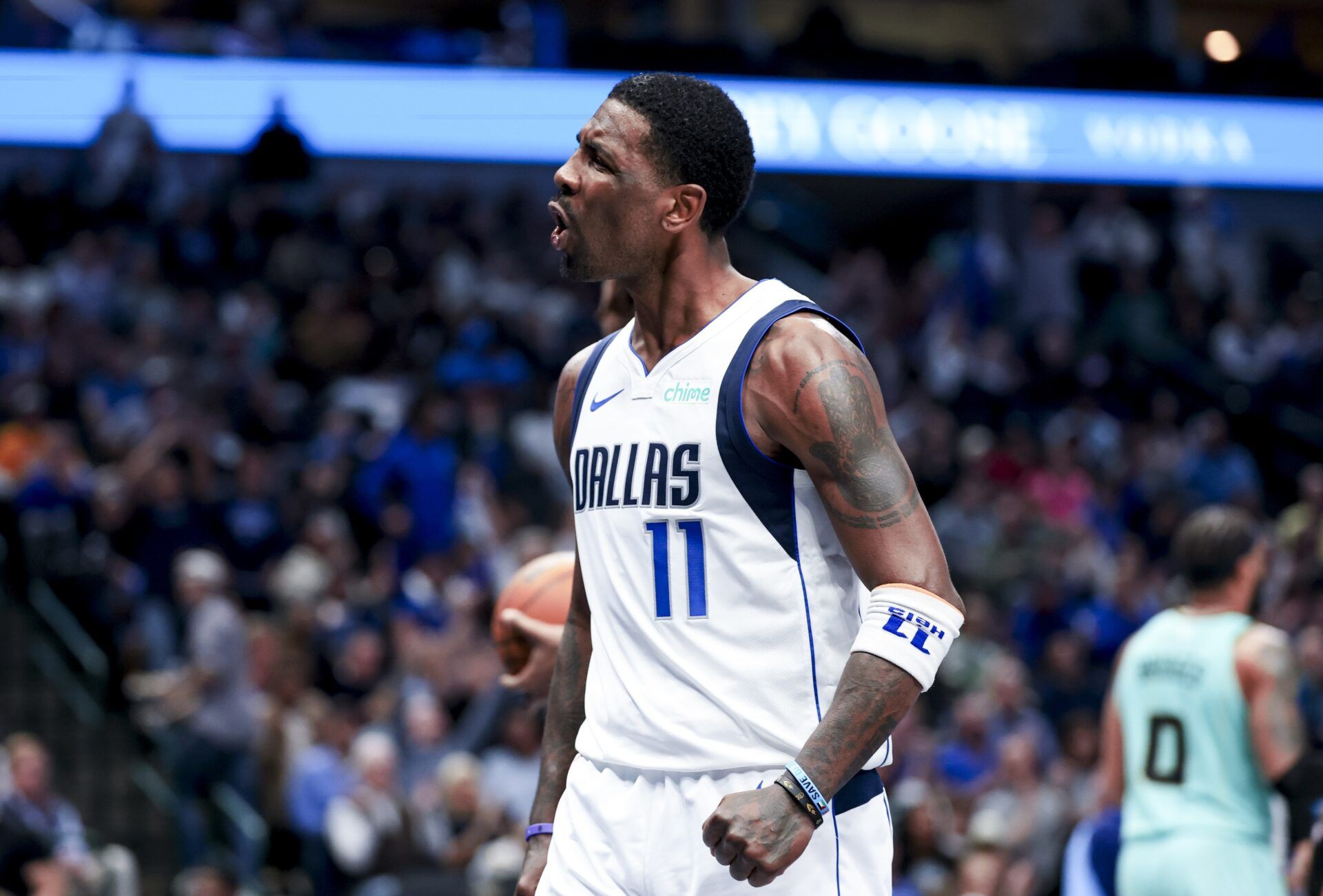 Dallas Mavericks guard Kyrie Irving (11) reacts after scoring against the Charlotte Hornets during the second half at American Airlines Center.