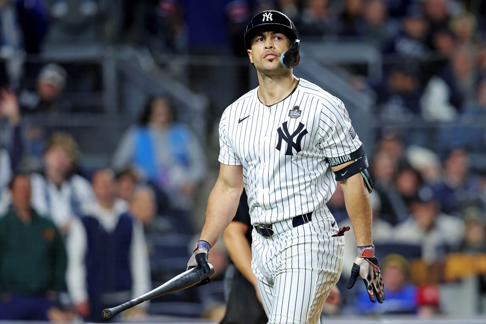 New York Yankees designated hitter Giancarlo Stanton (27) reacts after being called out on strikes during the eighth inning in game three of the 2024 MLB World Series at Yankee Stadium.