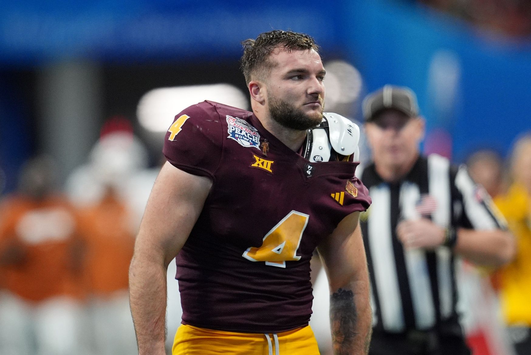 Arizona State Sun Devils running back Cam Skattebo (4) reacts after losing his helmet while being tackled by Texas Longhorns defensive back Michael Taaffe (16) during the second half of the Peach Bowl at Mercedes-Benz Stadium.