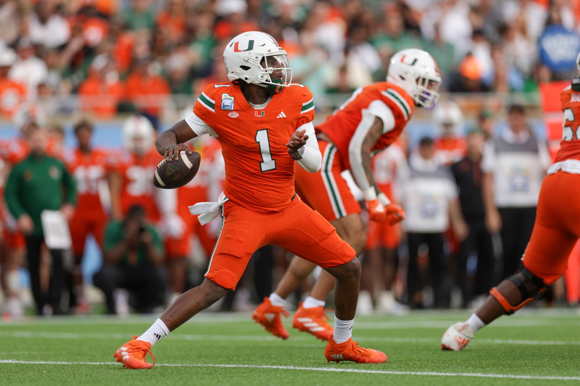 Dec 28, 2024; Orlando, FL, USA; Miami Hurricanes quarterback Cam Ward (1) drops back to pass against the Iowa State Cyclones in the first quarter during the Pop Tarts bowl at Camping World Stadium. Mandatory Credit: Nathan Ray Seebeck-Imagn Images