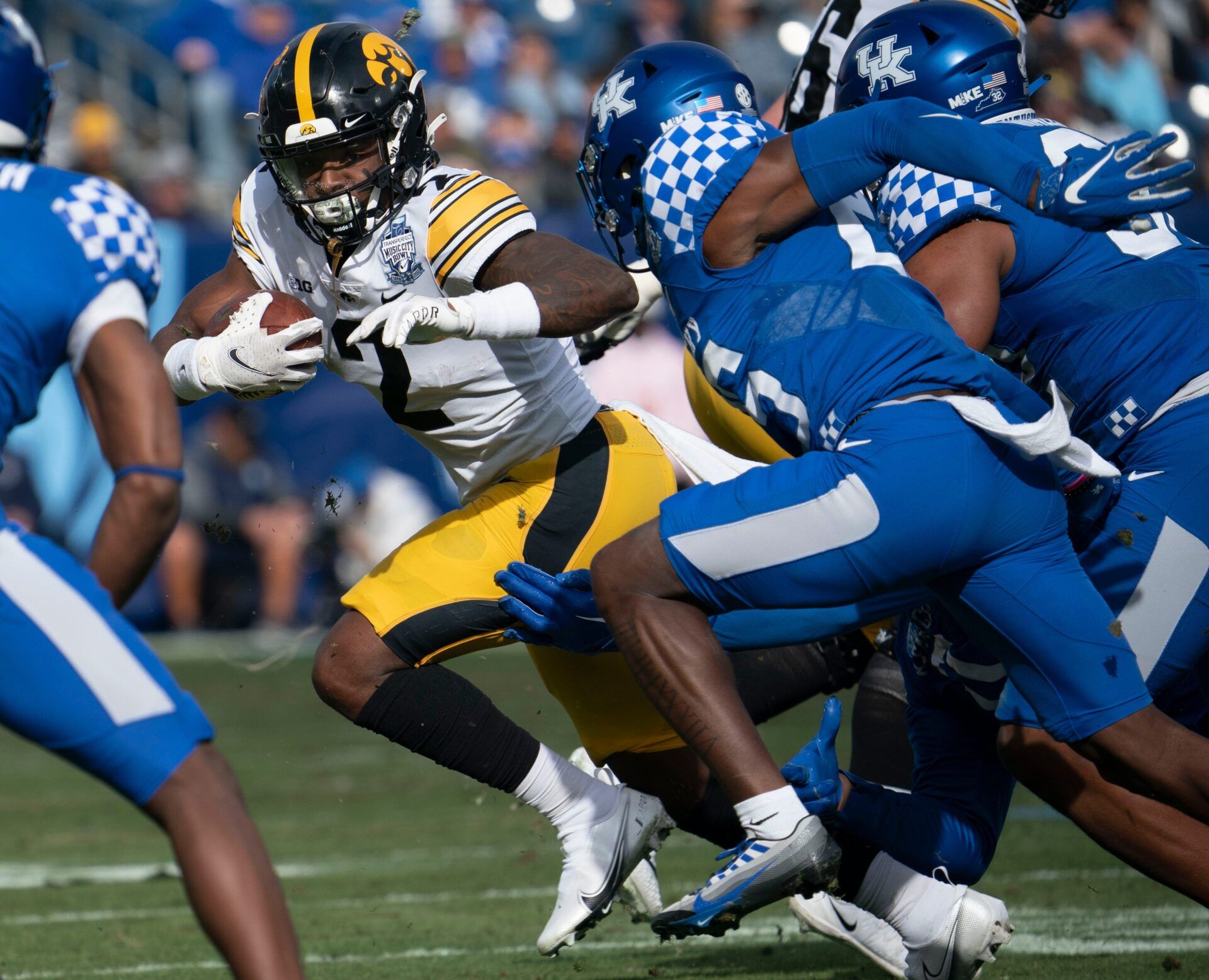 Iowa running back Kaleb Johnson (2) rushes past Kentucky defenders during the first quarter of the TransPerfect Music City Bowl, Saturday, Dec. 31, 2022, at Nissan Stadium in Nashville, Tenn.