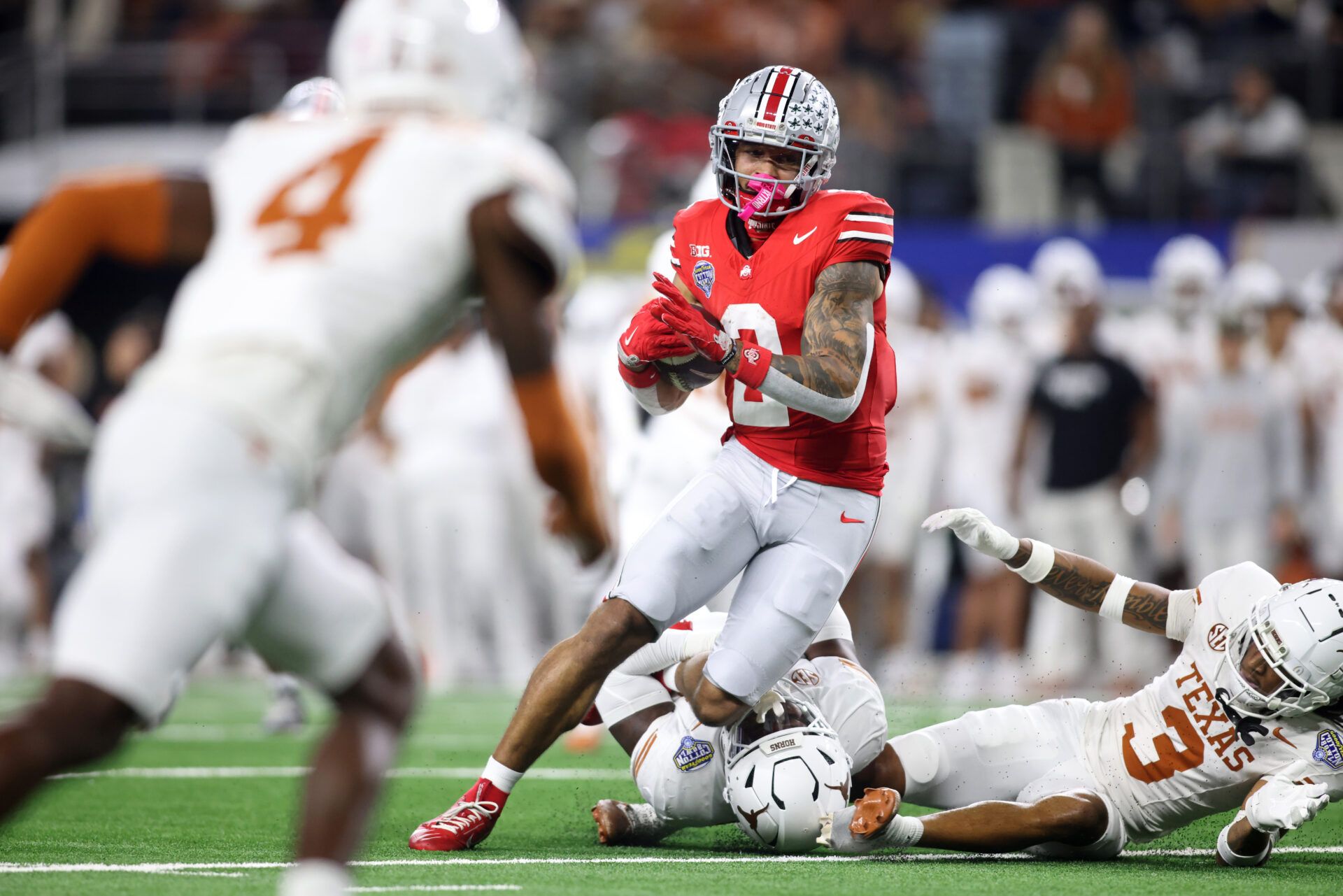 Jan 10, 2025; Arlington, Texas, USA; Ohio State Buckeyes wide receiver Emeka Egbuka (2) runs against Texas Longhorns defensive back Jaylon Guilbeau (3) during the first quarter of the College Football Playoff semifinal in the Cotton Bowl at AT&T Stadium. Mandatory Credit: Tim Heitman-Imagn Images