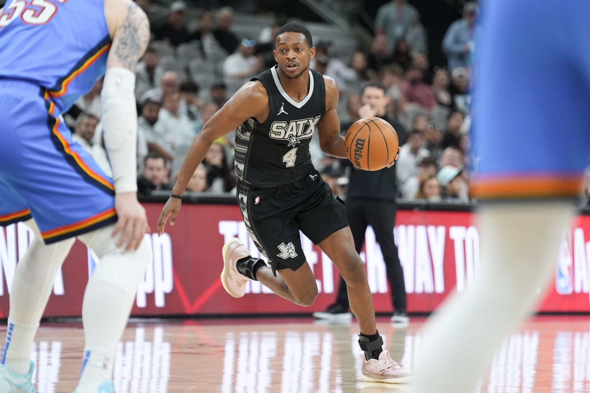 Mar 2, 2025; San Antonio, Texas, USA; San Antonio Spurs guard De'Aaron Fox (4) dribbles in the first half against the Oklahoma City Thunder at Frost Bank Center. Mandatory Credit: Daniel Dunn-Imagn Images