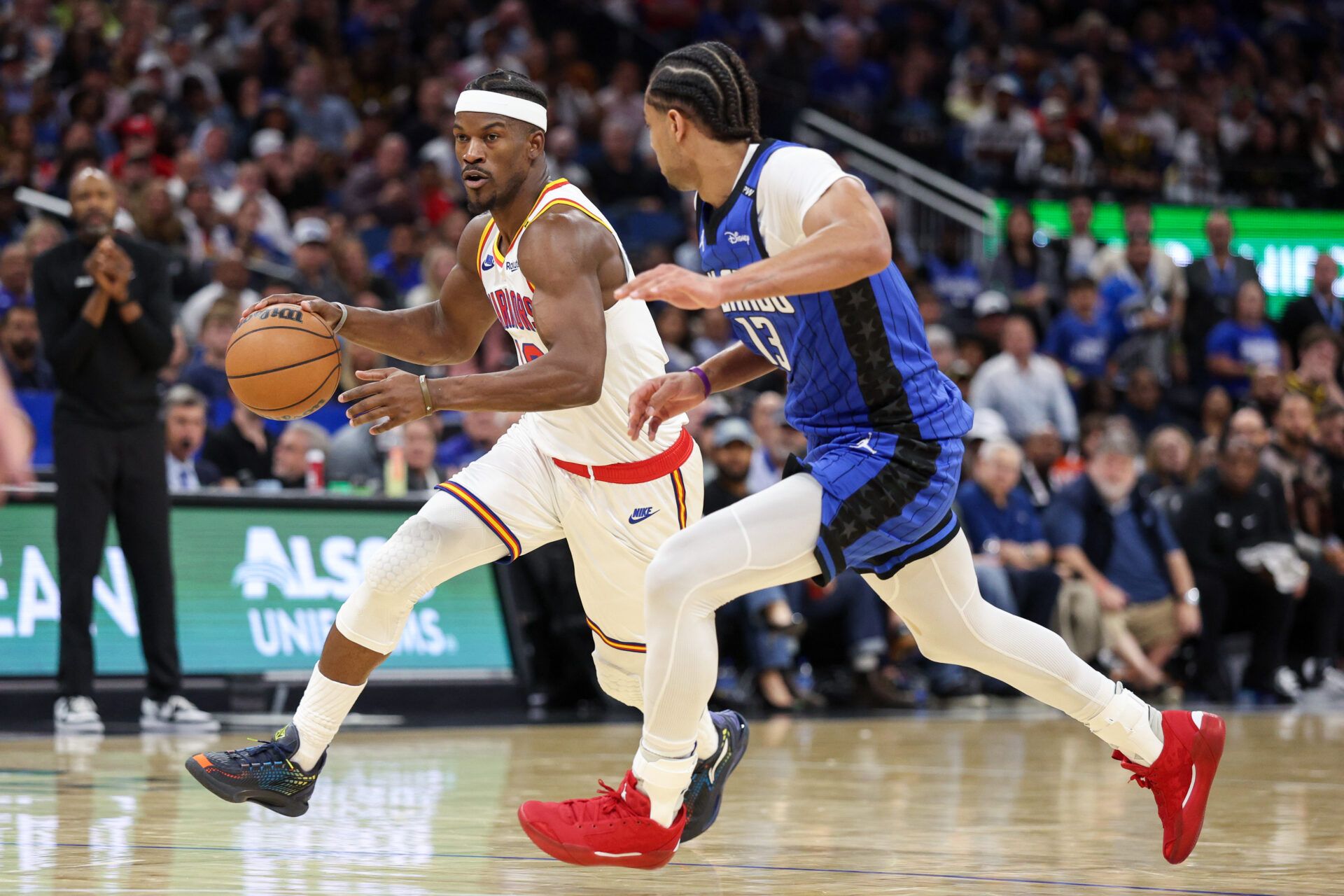 Feb 27, 2025; Orlando, Florida, USA; Golden State Warriors forward Jimmy Butler III (10) moves the ball past Orlando Magic guard Jett Howard (13) in the third quarter at Kia Center. Mandatory Credit: Nathan Ray Seebeck-Imagn Images