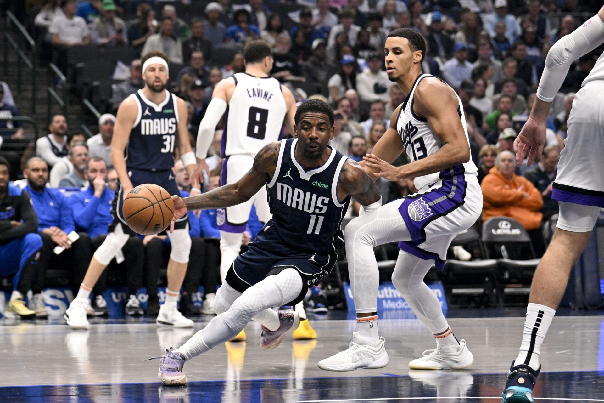 Dallas Mavericks guard Kyrie Irving (11) drives to the basket past Sacramento Kings forward Keegan Murray (13) during the first quarter at the American Airlines Center.