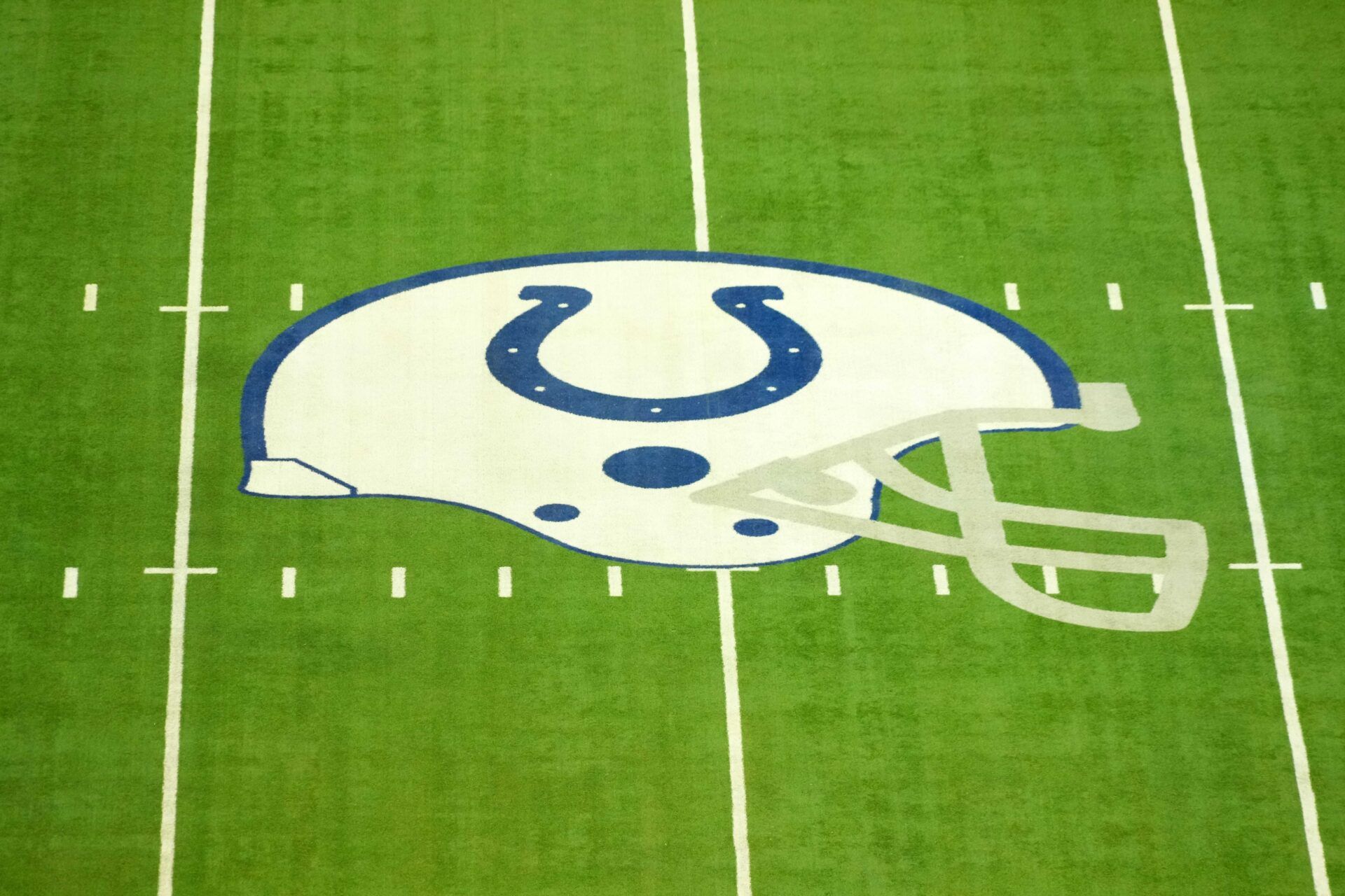 The Indianapolis Colts helmet logo at midfield at Lucas Oil Stadium.