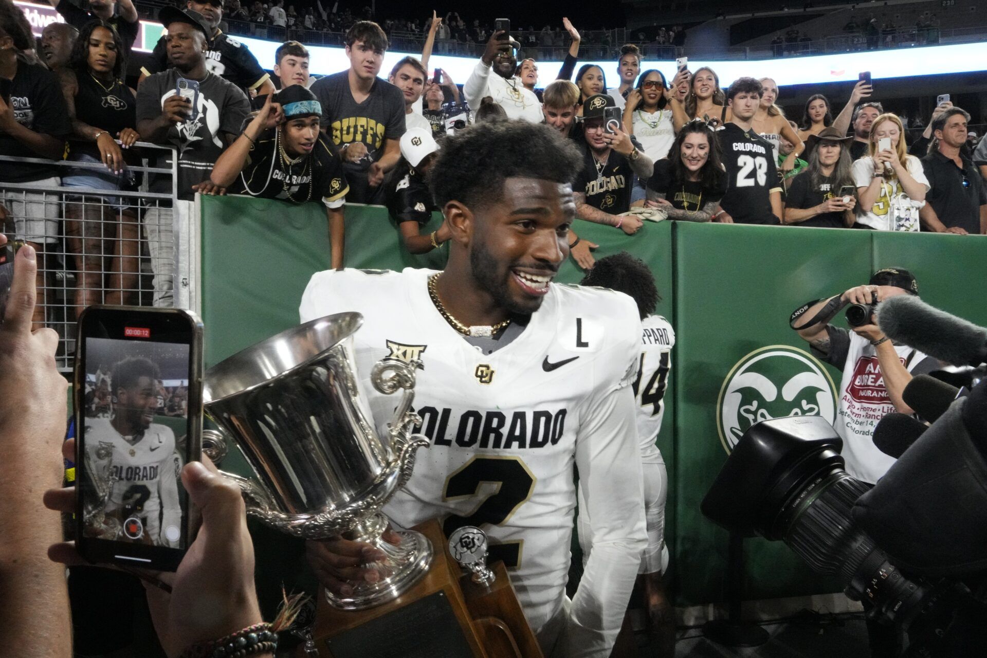 Colorado Buffaloes quarterback Shedeur Sanders (2) celebrates with the Centennial Cup after the Buffaloes 28-9 victory over the Colorado State Rams Sonny Lubick Field at Canvas Stadium.