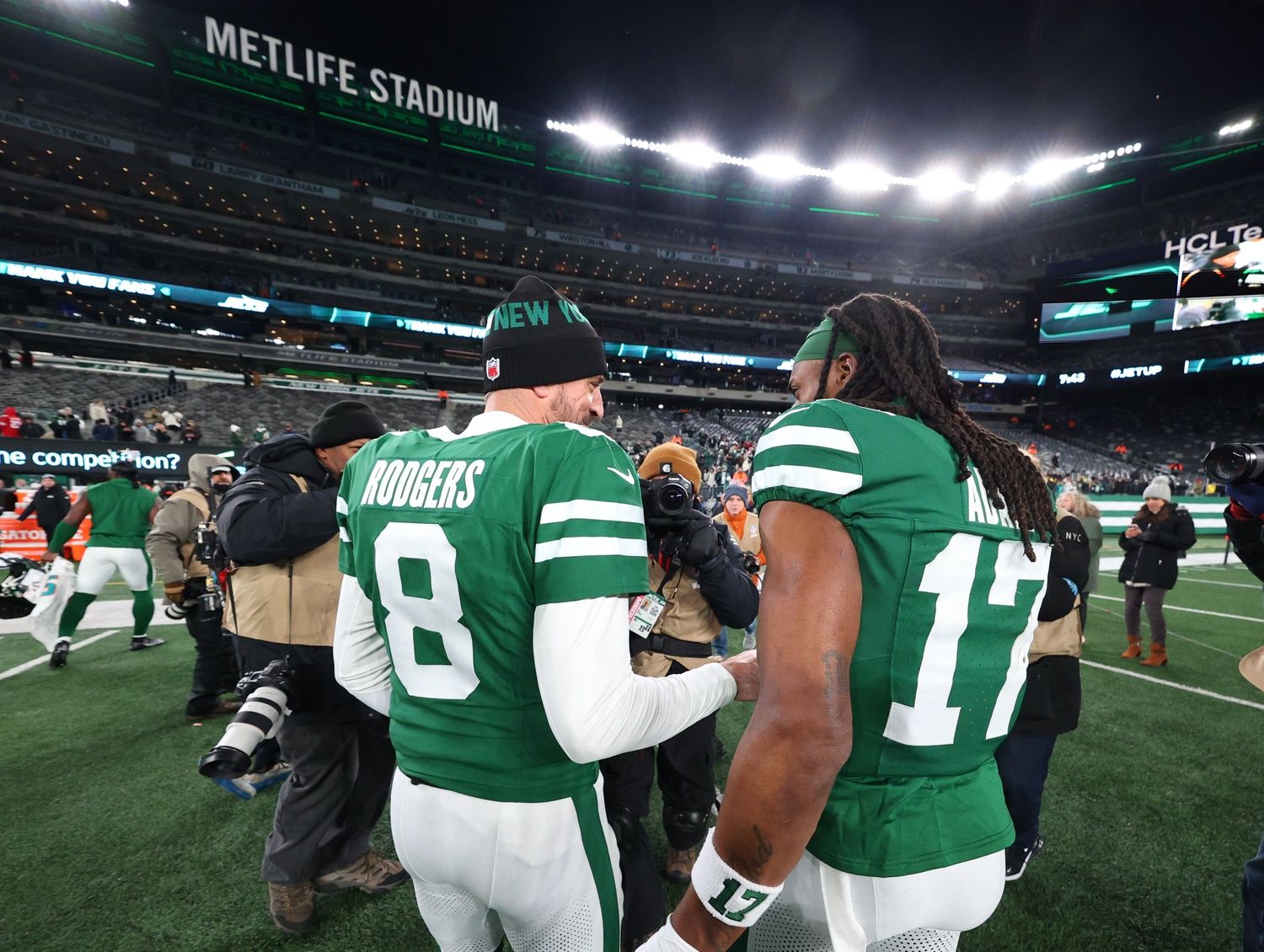 New York Jets quarterback Aaron Rodgers (8) and wide receiver Davante Adams (17) walk on the field after the Jets win over the Miami Dolphins at MetLife Stadium.