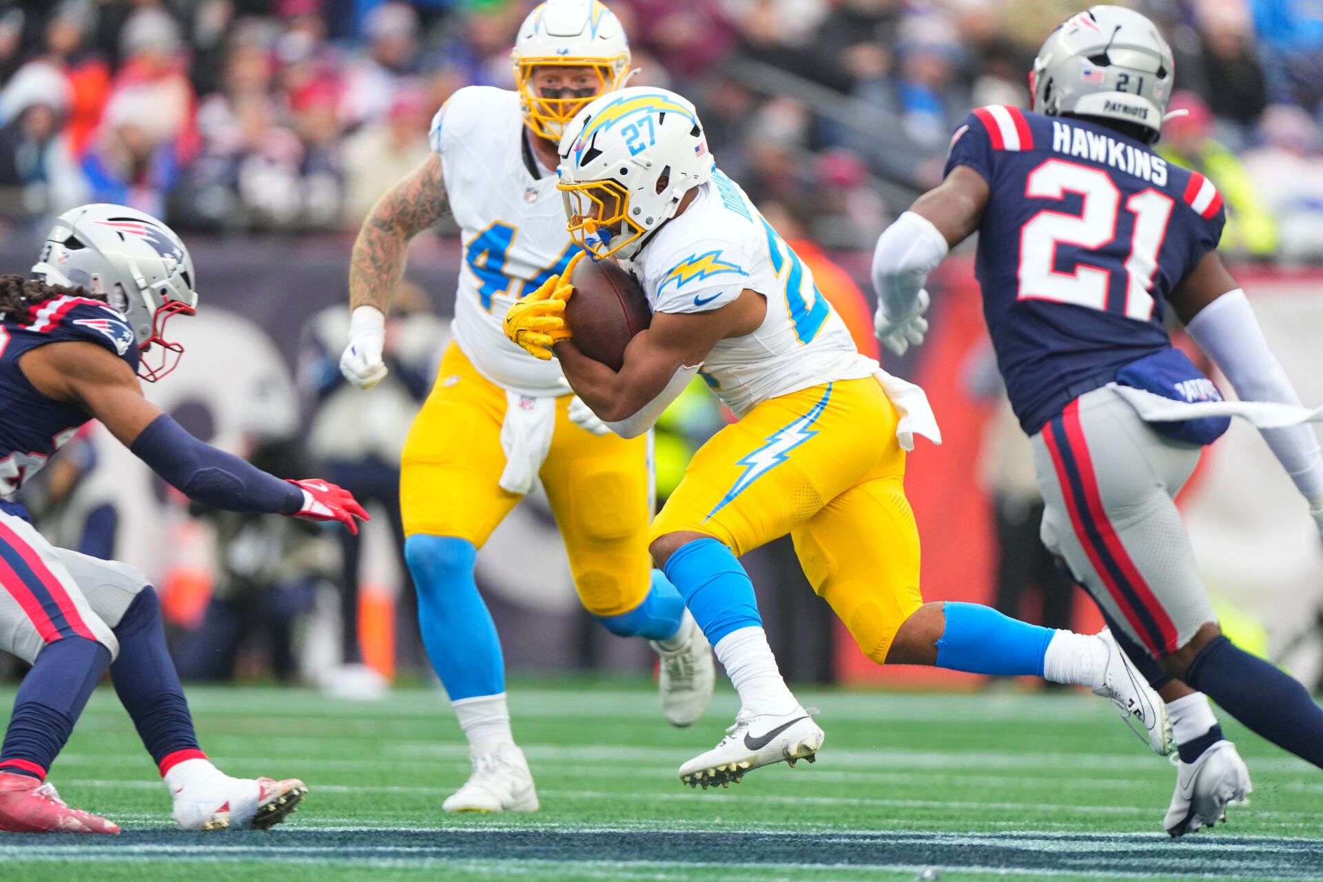 Dec 28, 2024; Foxborough, Massachusetts, USA; Los Angeles Chargers running back J.K. Dobbins (27) runs with the ball against the New England Patriots during the first half at Gillette Stadium. Mandatory Credit: Gregory Fisher-Imagn Images