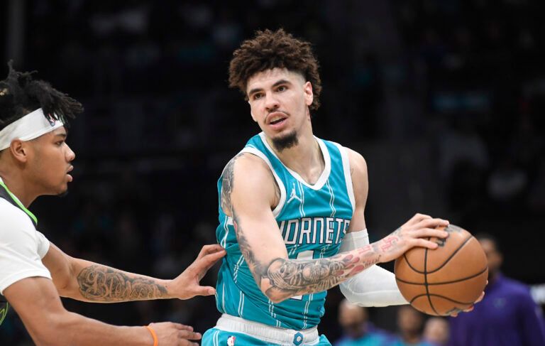 Mar 5, 2025; Charlotte, North Carolina, USA; Charlotte Hornets guard LaMelo Ball (1) controls the ball as he is defended by Minnesota Timberwolves guard Terrence Shannon Jr. (00) during the first half at the Spectrum Center. Mandatory Credit: Sam Sharpe-Imagn Images