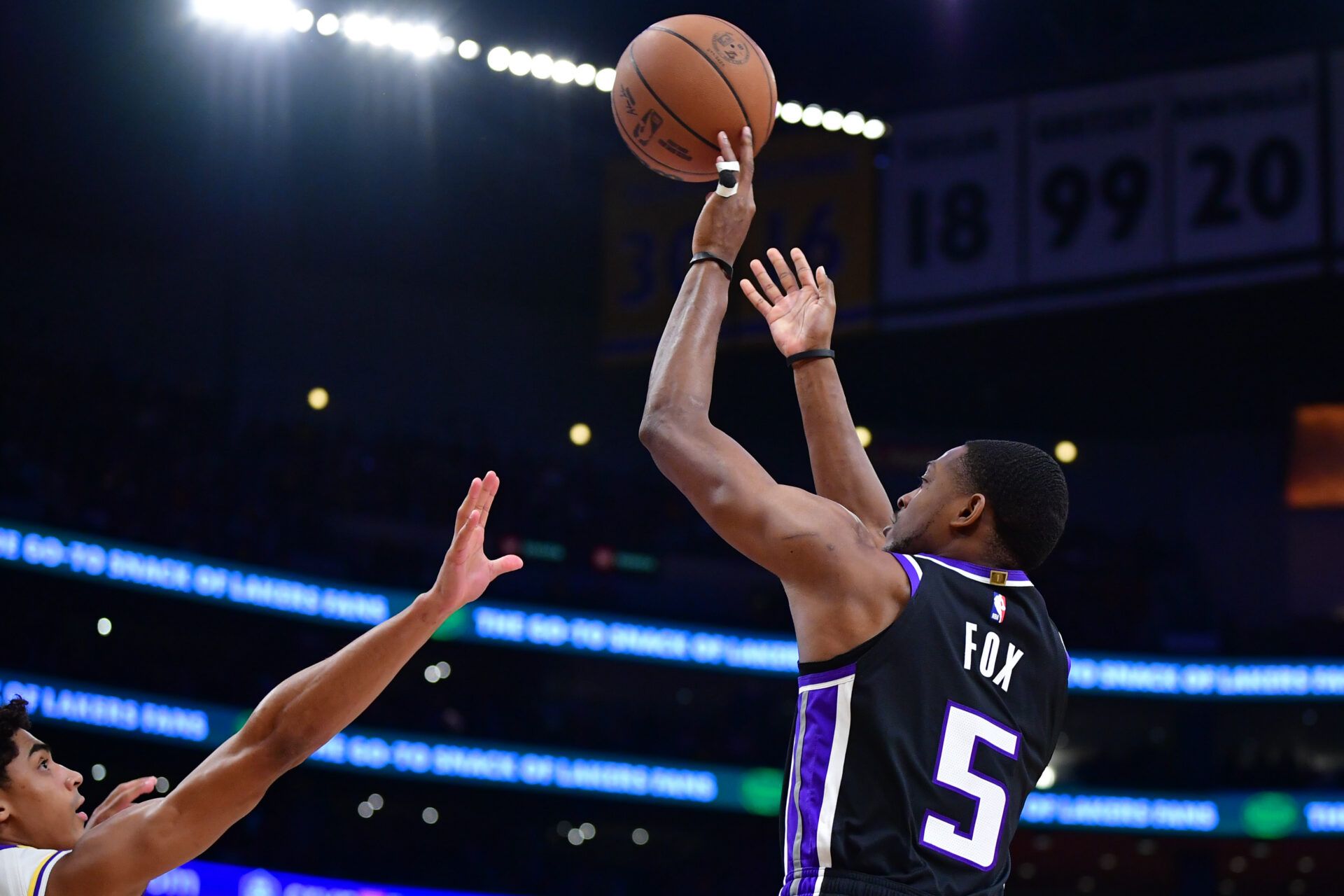 Dec 28, 2024; Los Angeles, California, USA; Sacramento Kings guard De’Aaron Fox (5) shoots against Los Angeles Lakers guard Max Christie (12) during the first half at Crypto.com Arena. Mandatory Credit: Gary A. Vasquez-Imagn Images