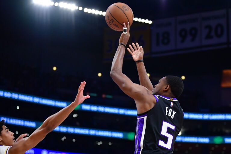 Dec 28, 2024; Los Angeles, California, USA; Sacramento Kings guard De’Aaron Fox (5) shoots against Los Angeles Lakers guard Max Christie (12) during the first half at Crypto.com Arena. Mandatory Credit: Gary A. Vasquez-Imagn Images