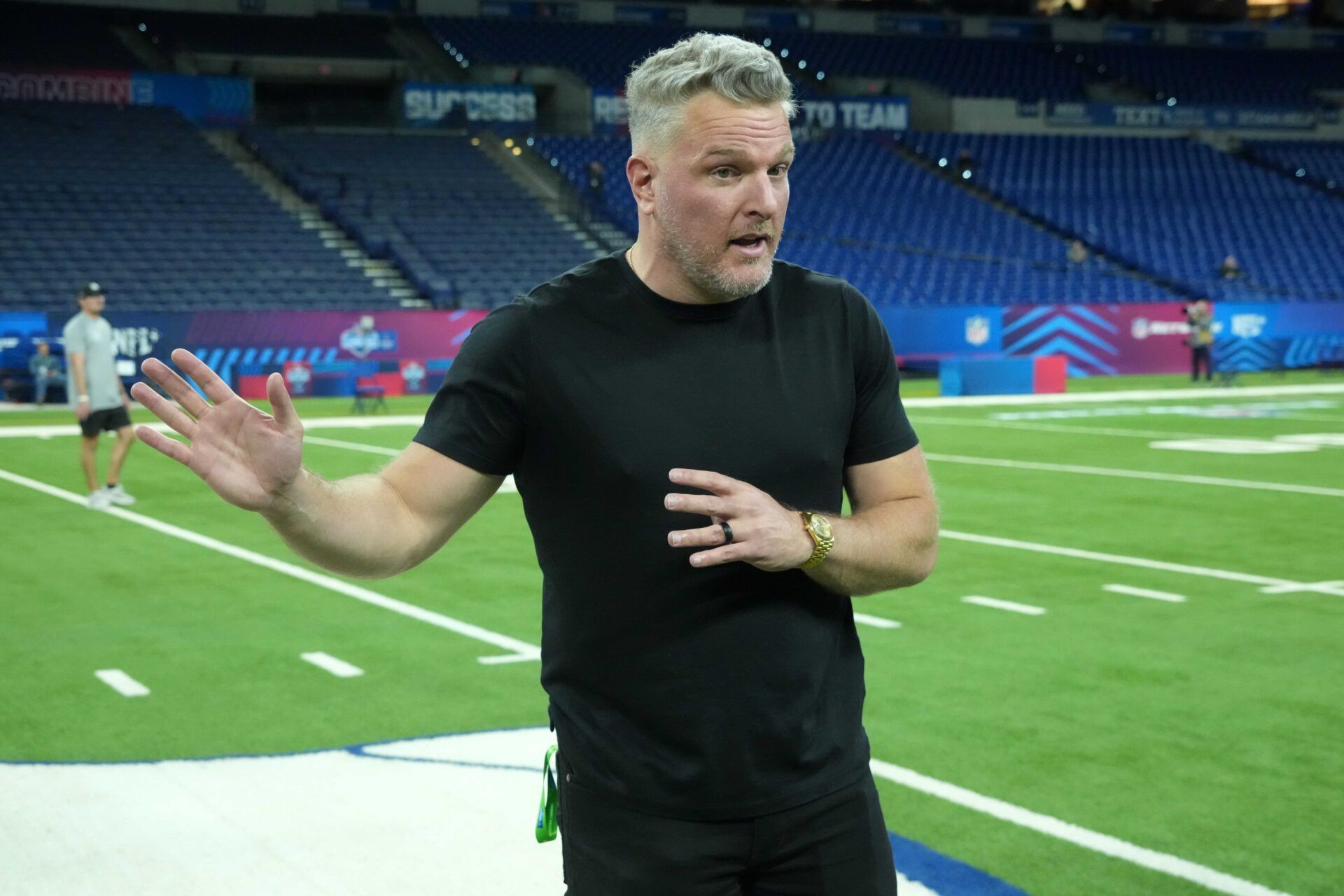 Pat McAfee watches during workouts at the 2025 NFL Scouting Combine at Lucas Oil Stadium.