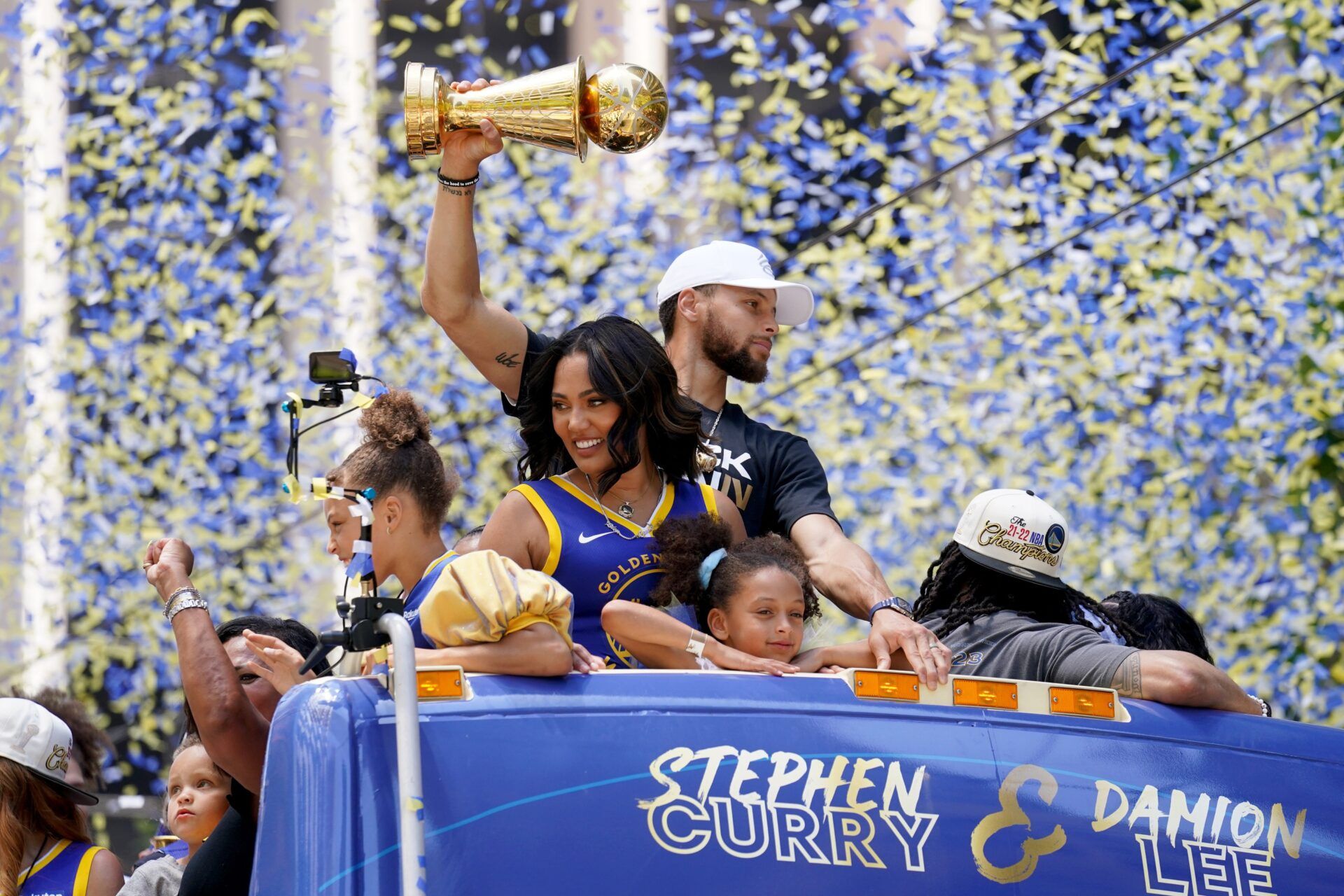 Golden State Warriors guard Stephen Curry holds the NBA Finals Most Valuable Player Award trophy next to his wife Ayesha during the Warriors championship parade in downtown San Francisco.