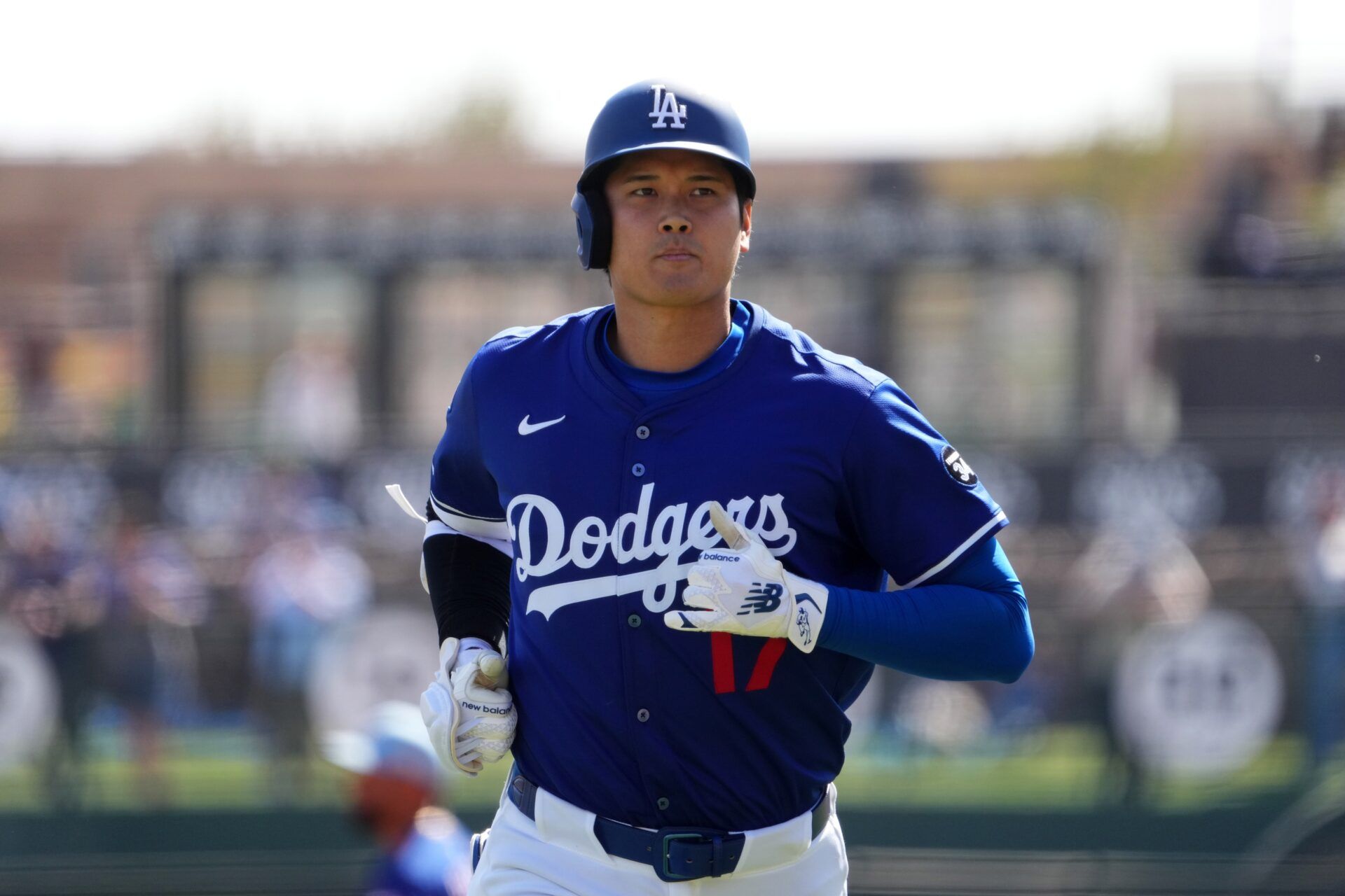 Los Angeles Dodgers two-way player Shohei Ohtani (17) returns to the dugout after an at bat against the Texas Rangers during the third inning at Camelback Ranch-Glendale.