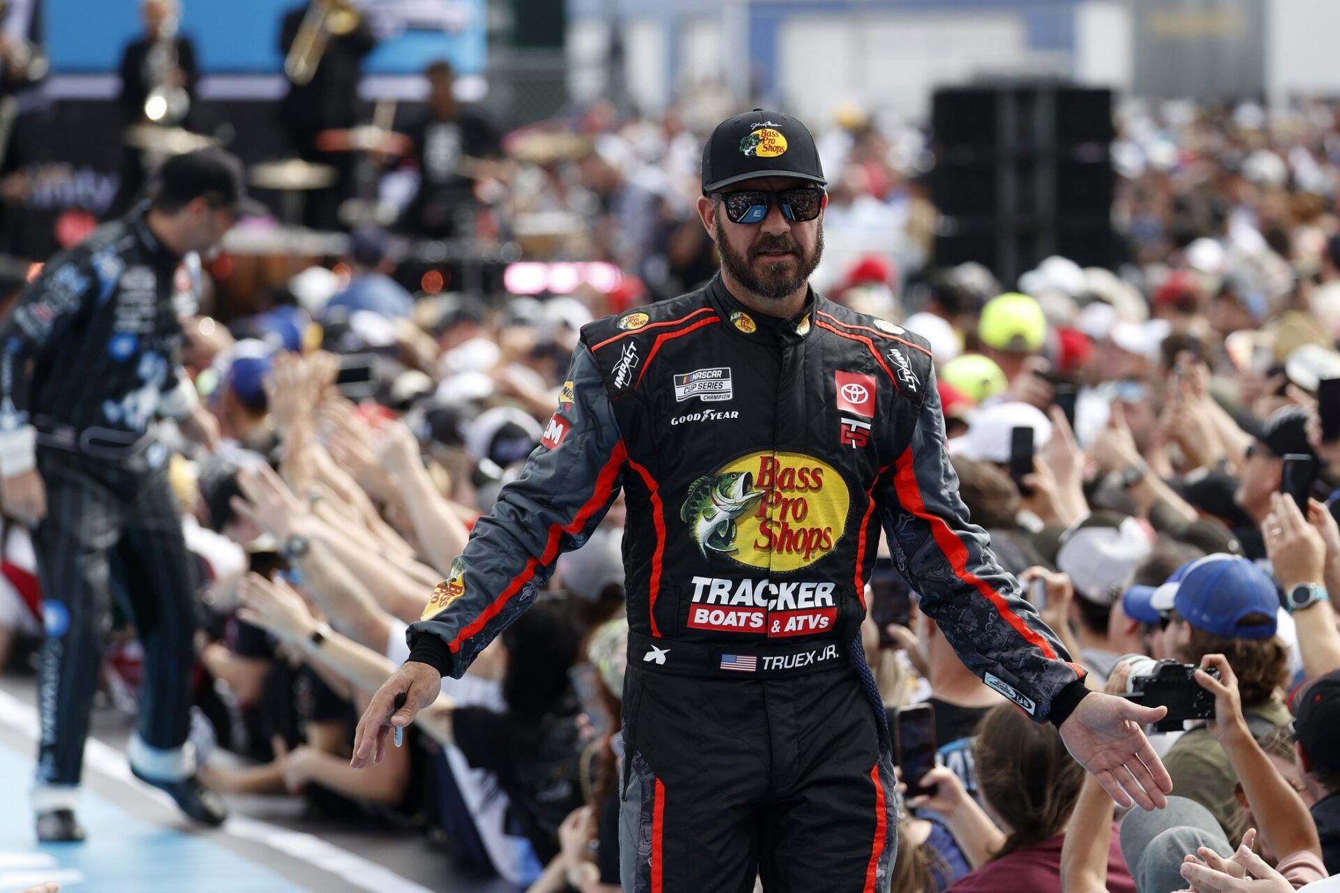 NASCAR Cup Series driver Martin Truex Jr. (56) walks onto the driver introduction stage to greet fans before the Daytona 500 at Daytona International Speedway.
