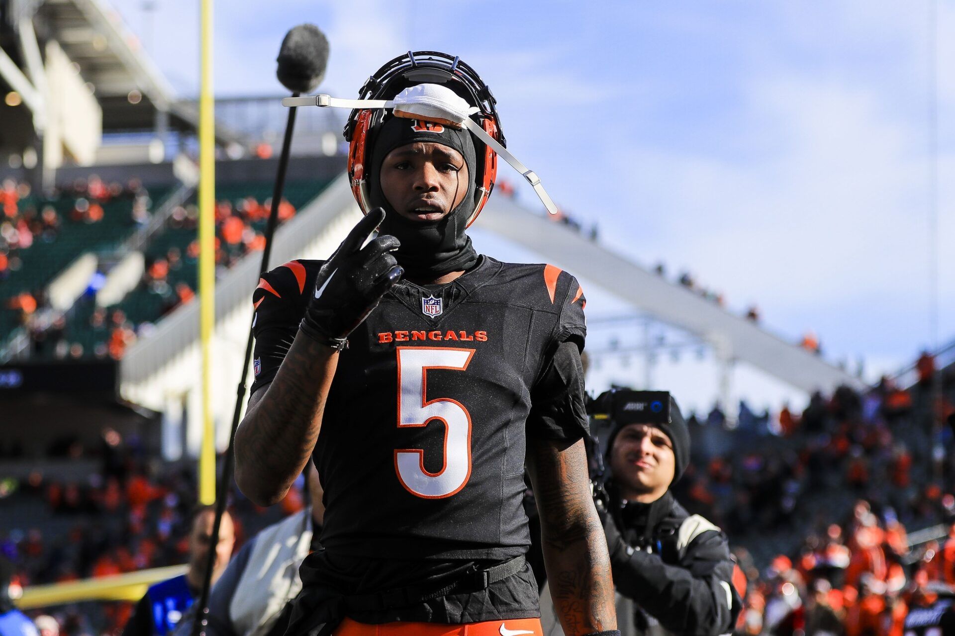 Cincinnati Bengals wide receiver Tee Higgins (5) acknowledges fans during warmups before the game against the Cleveland Browns at Paycor Stadium.