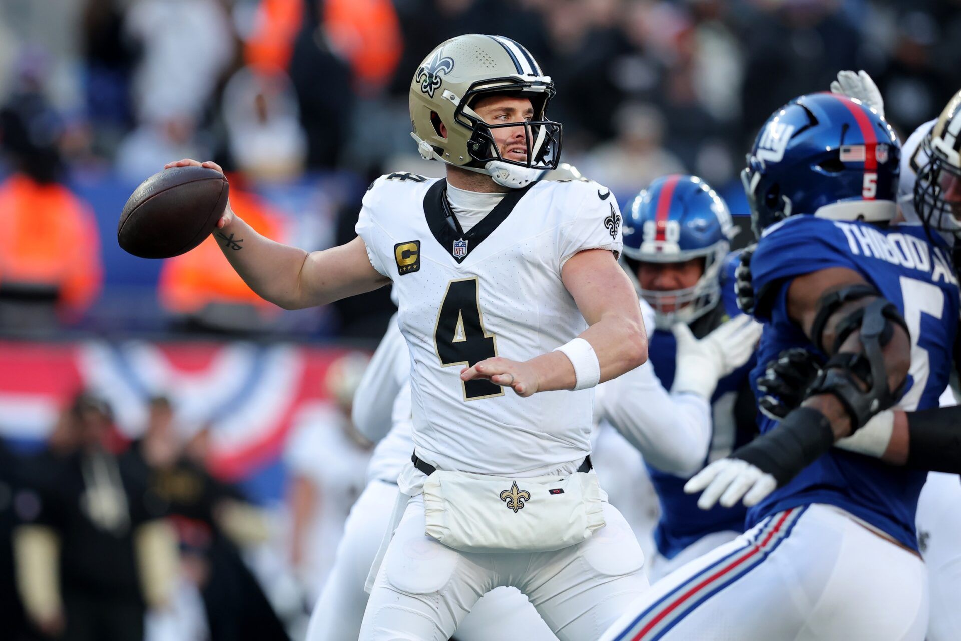 New Orleans Saints quarterback Derek Carr (4) drops back to pass against the New York Giants during the third quarter at MetLife Stadium.