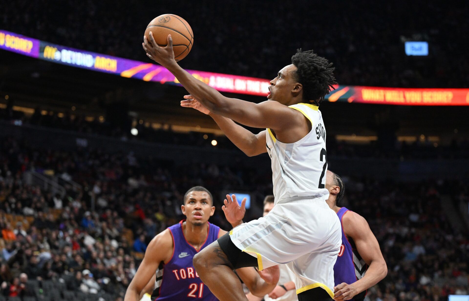 Utah Jaz guard Collin Sexton (2 drives for a layup as Toronto Raptors center Orlando Robinson (21) looks on in the second half at Scotiabank Arena