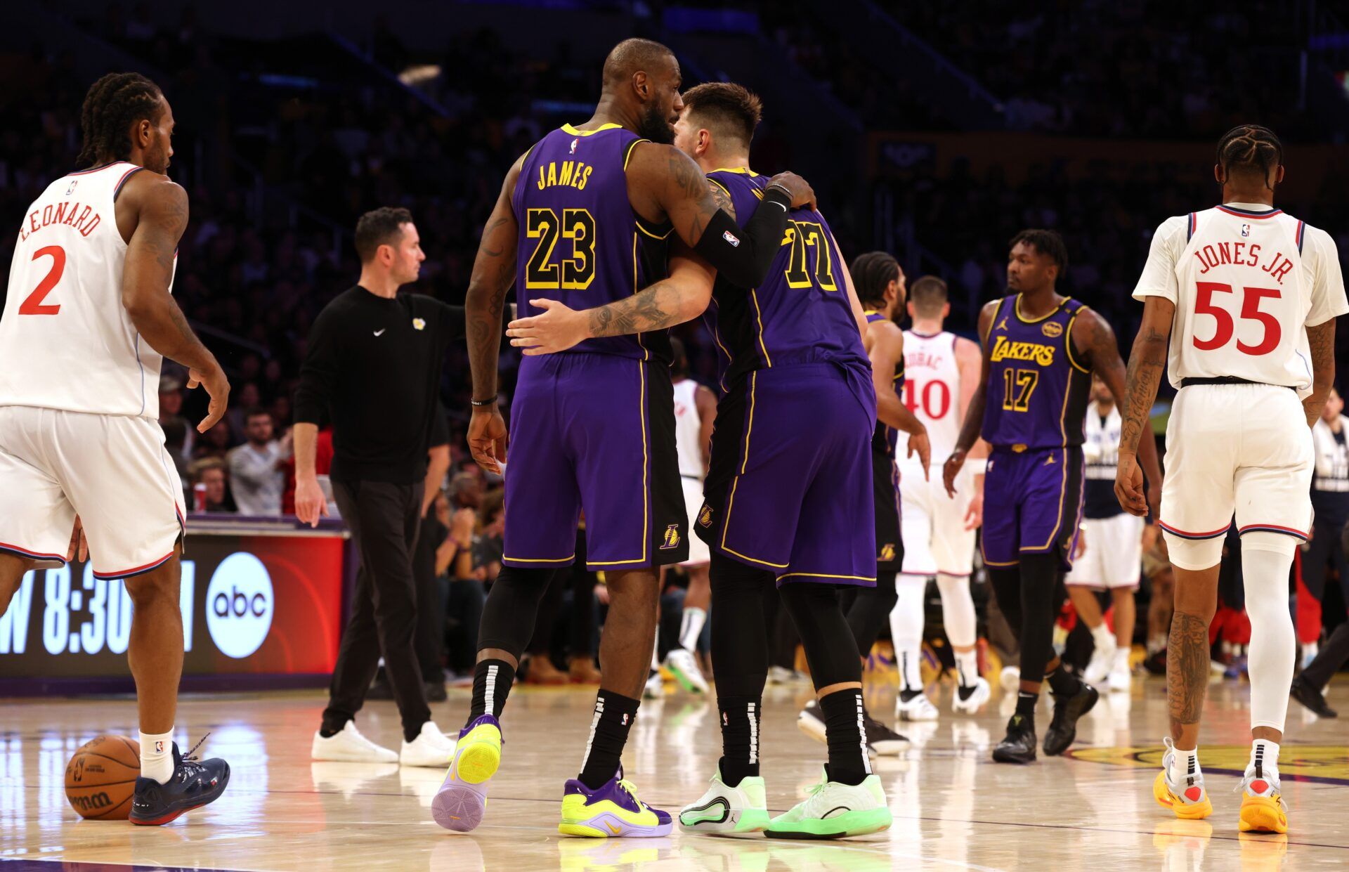 Los Angeles Lakers forward LeBron James (23) and guard Luka Doncic (77) react after a play during the fourth quarter against the LA Clippers at Crypto.com Arena.