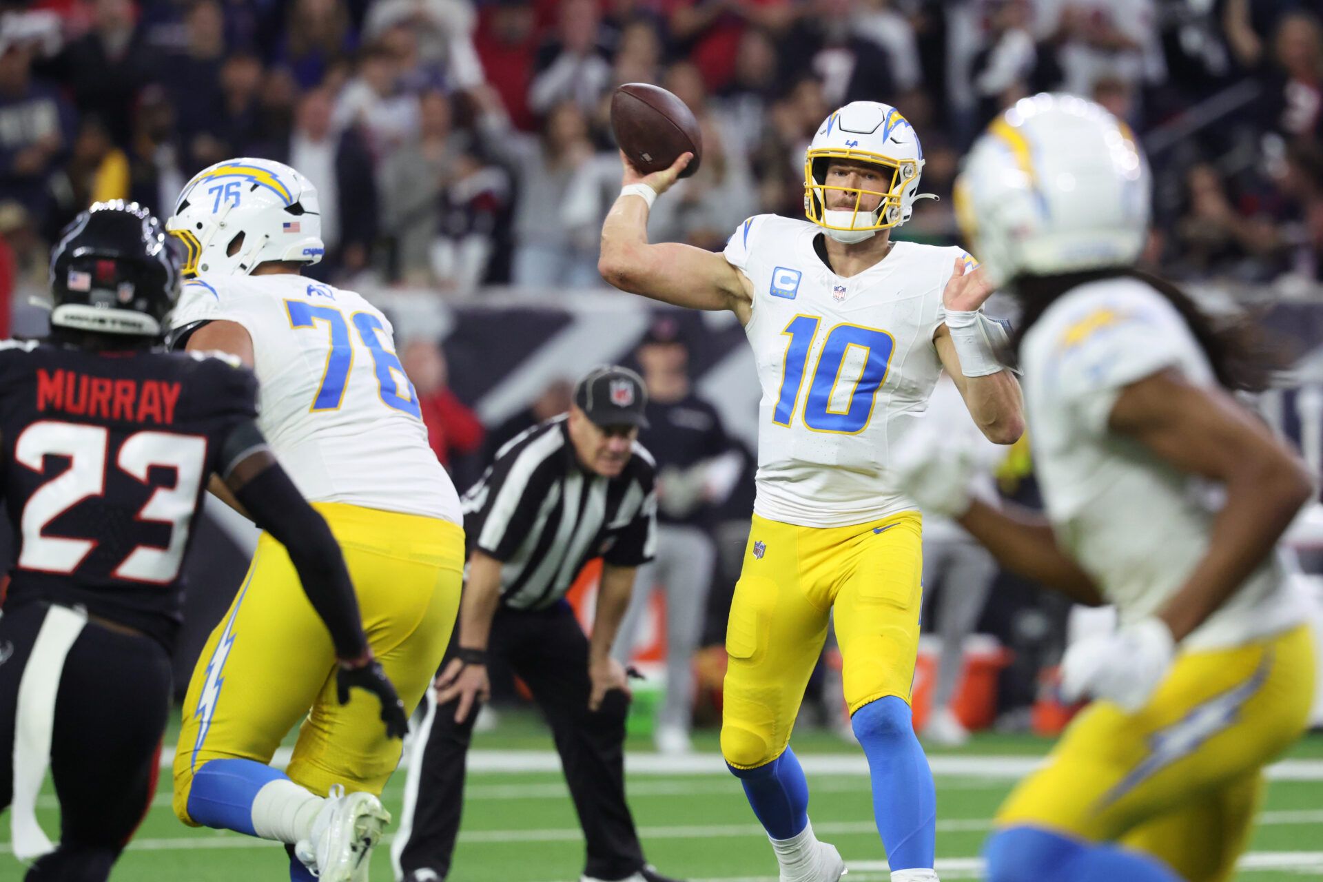 Justin Herbert throws a pass to a receiver.