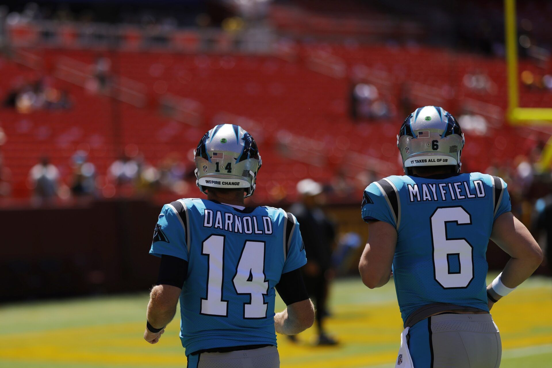 Carolina Panthers quarterback Sam Darnold (14) and Panthers quarterback Baker Mayfield (6) jog onto the field for warmups prior to the game against the Washington Commanders at FedExField.