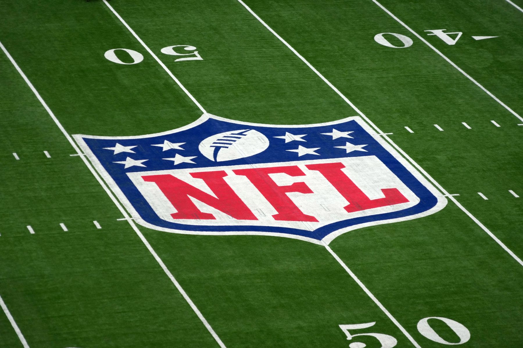 The NFL shield logo at midfield before an NFL International Series game at Tottenham Hotspur Stadium.