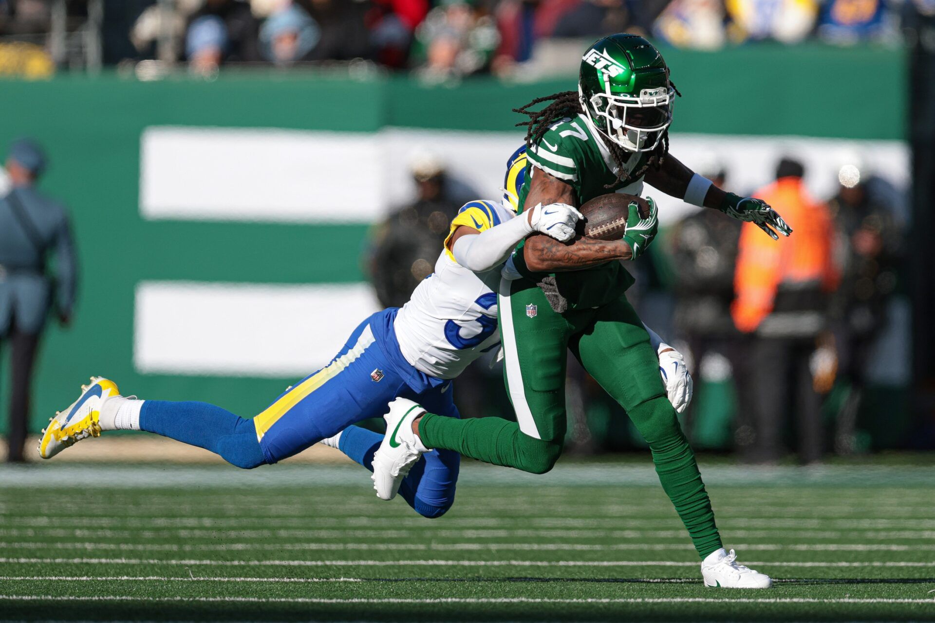 New York Jets wide receiver Davante Adams (17) fights for yards as Los Angeles Rams safety Quentin Lake (37) tackles during the first half at MetLife Stadium.