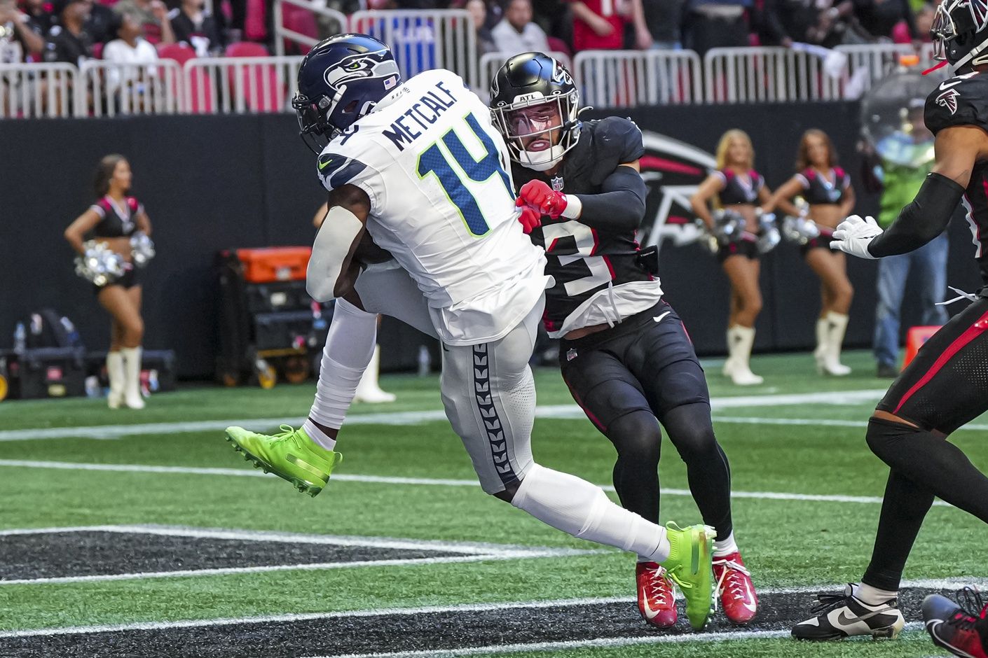 Seattle Seahawks wide receiver DK Metcalf (14) catches a touchdown pass behind Atlanta Falcons safety Jessie Bates III (3) during the first half at Mercedes-Benz Stadium.