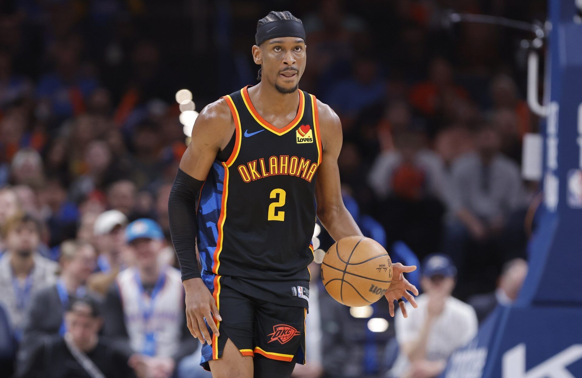 Oklahoma City Thunder guard Shai Gilgeous-Alexander (2) dribbles down the court against the Denver Nuggets during the second half at Paycom Center.