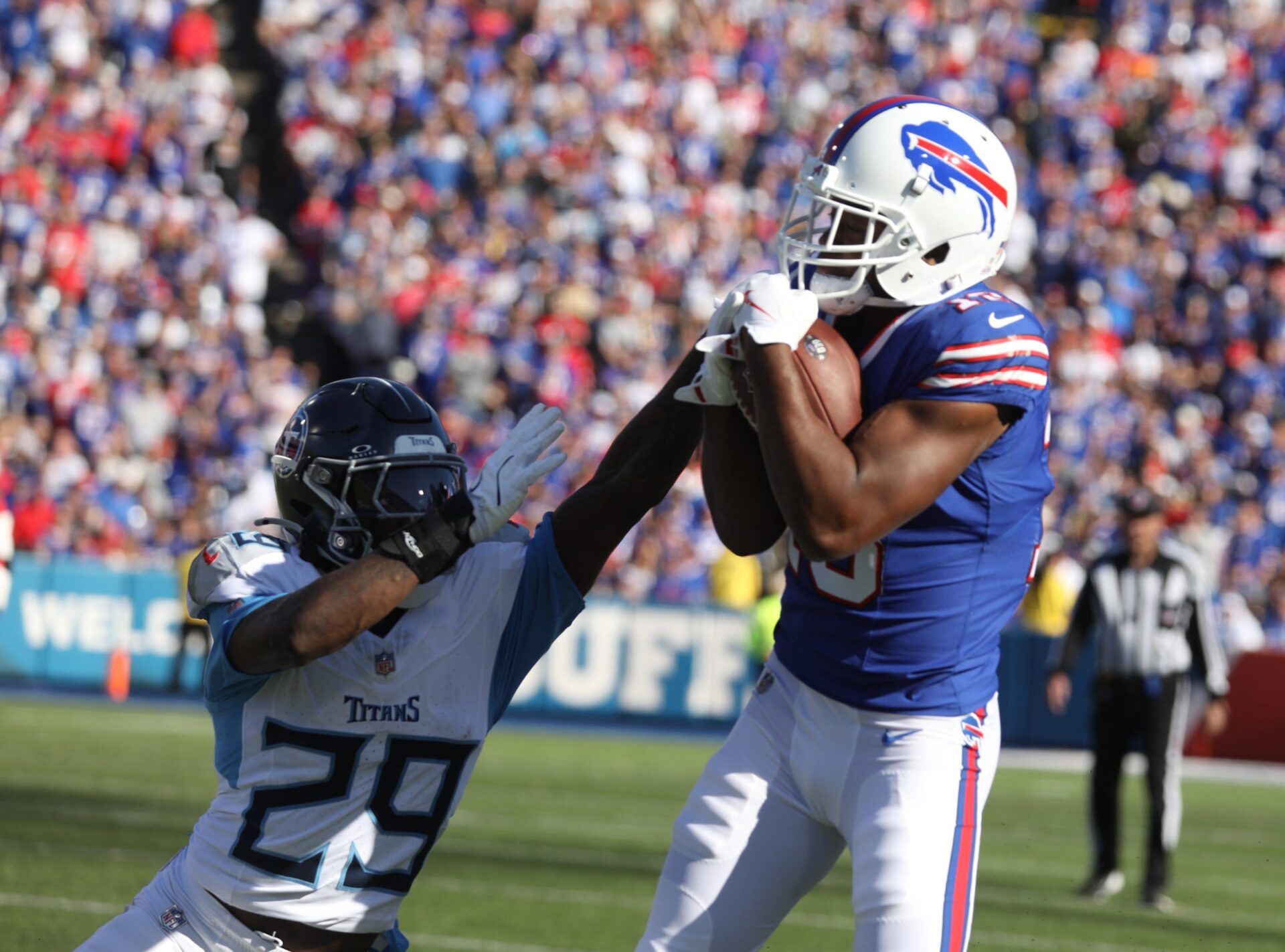 Bills Amari Cooper hauls in a pass and keeping Titans Jarvis Brownlee Jr. from stripping it from him during second half action at Highmark Stadium in Orchard Park on Oct. 20, 2024.