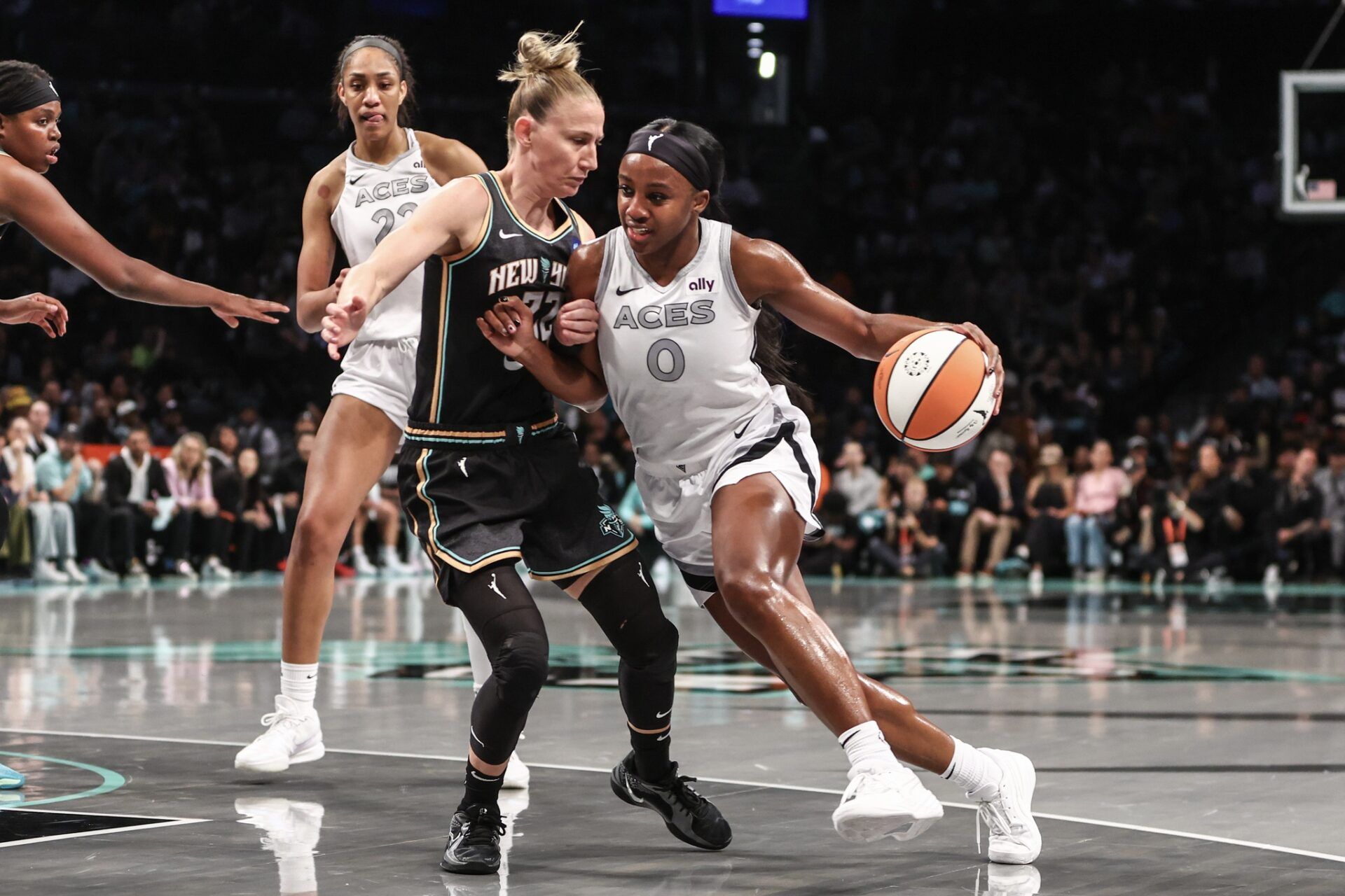 Las Vegas Aces guard Jackie Young (0) drives past New York Liberty guard Courtney Vandersloot (22) in the first quarter during game two of the 2024 WNBA Semi-finals at Barclays Center.