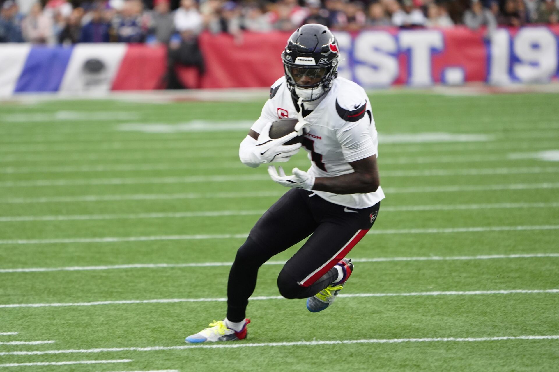 Houston Texans wide receiver Stefon Diggs (1) runs with the ball after making a catch against the New England Patriots during the first half at Gillette Stadium.