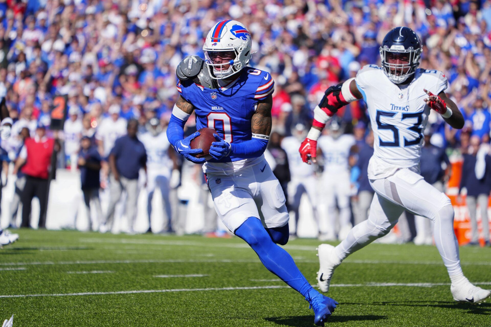 Buffalo Bills wide receiver Keon Coleman (0) runs with the ball after making a catch against Tennessee Titans linebacker Ernest Jones IV (53) during the first half at Highmark Stadium.