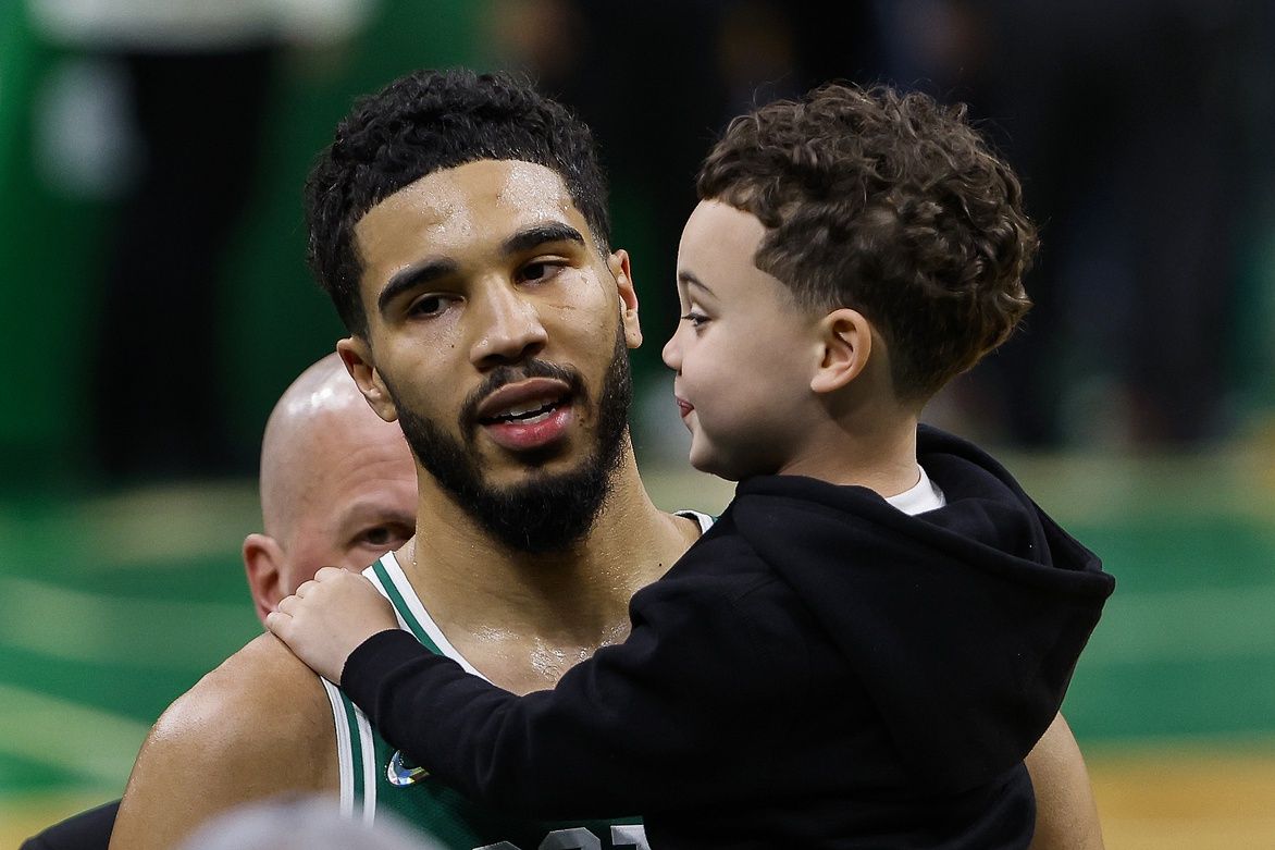 Boston Celtics forward Jayson Tatum (0) carries his son, Jason Jr. off the court following their win over the Brooklyn Nets in game two of the first round of the 2022 NBA playoffs at TD Garden.